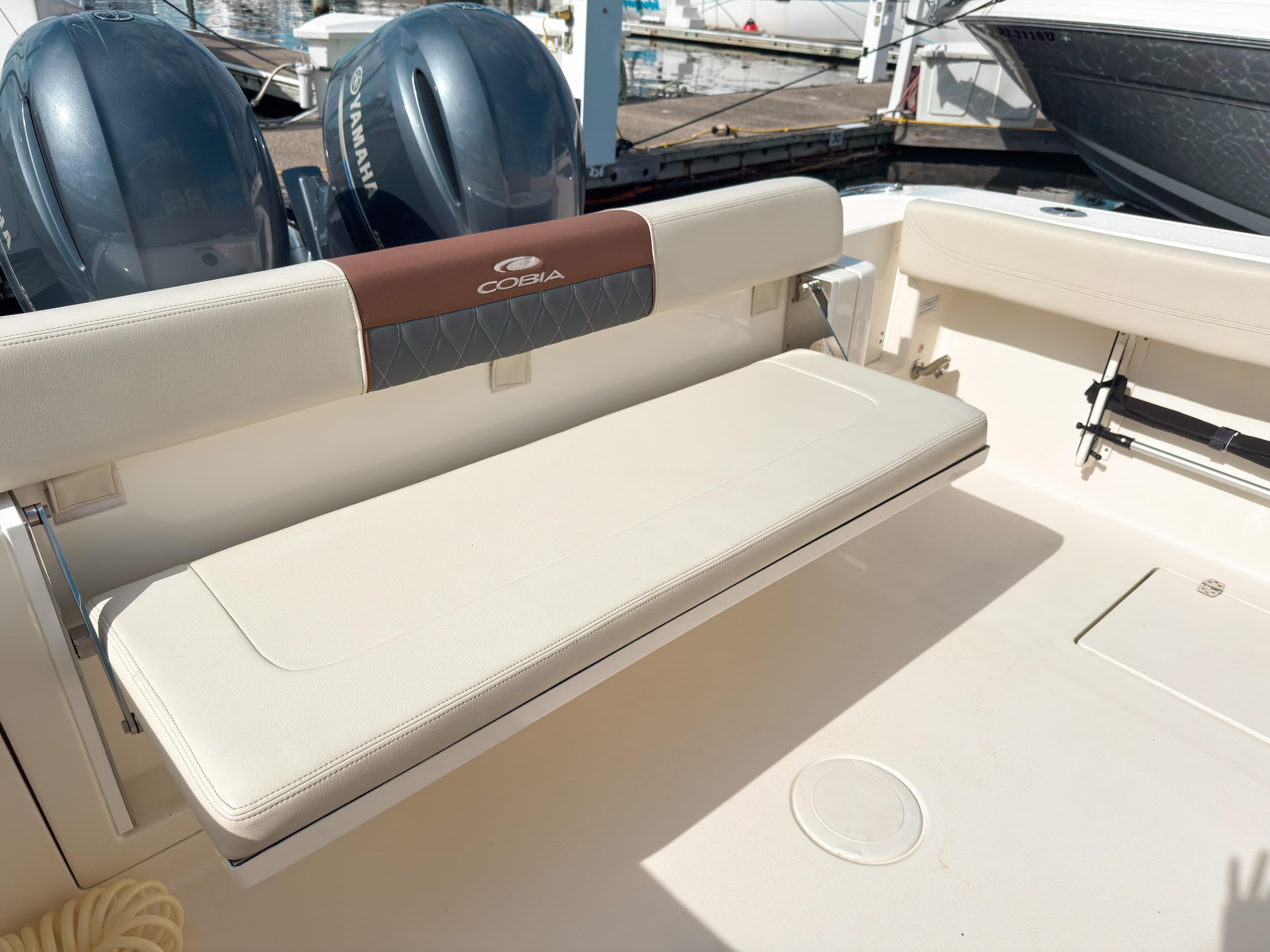 2023 Cobia 280 Center Console boat with foldable seating and twin Yamaha engines.