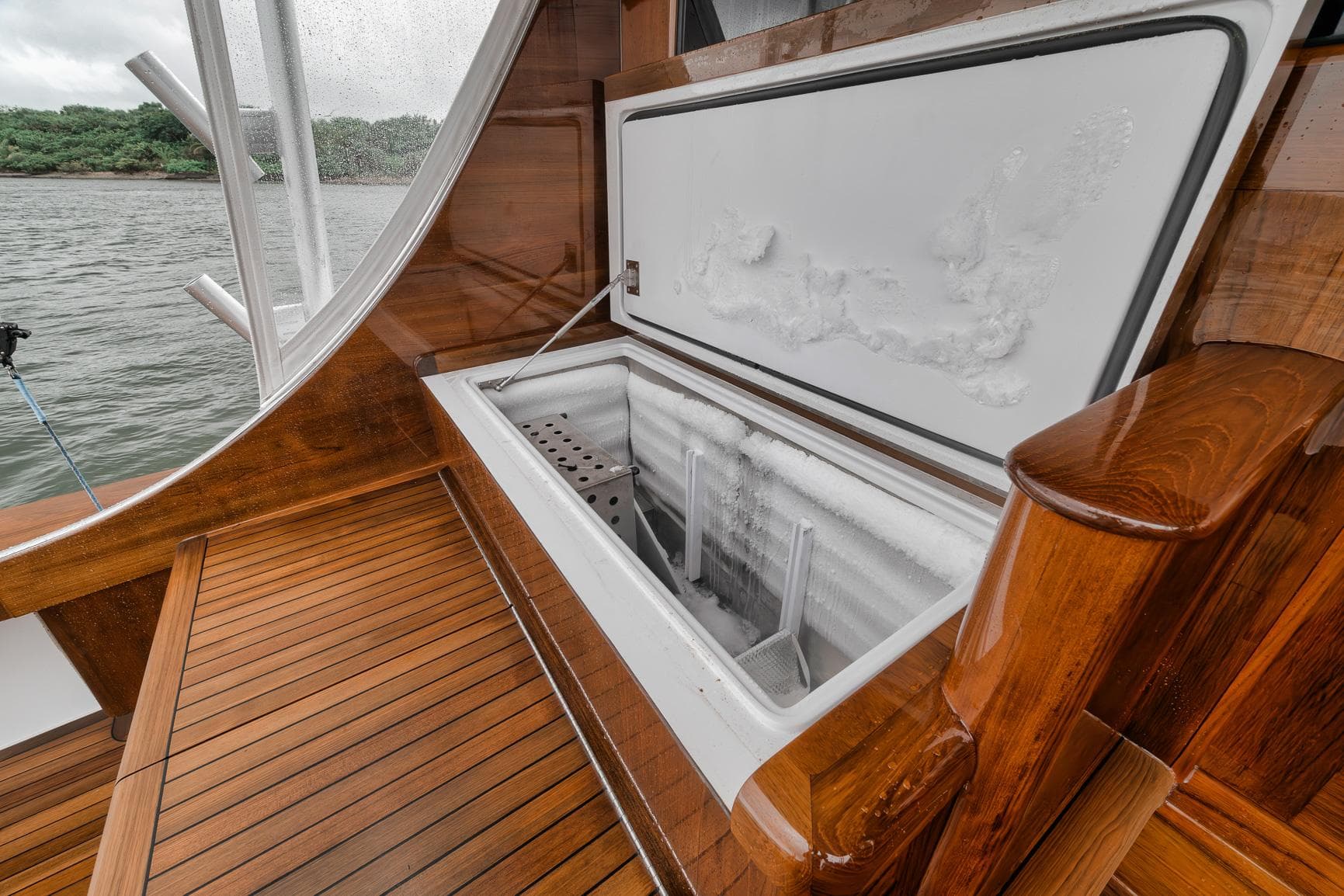 Open freezer on 2011 Jim Smith Custom Sportfish boat with wooden deck.