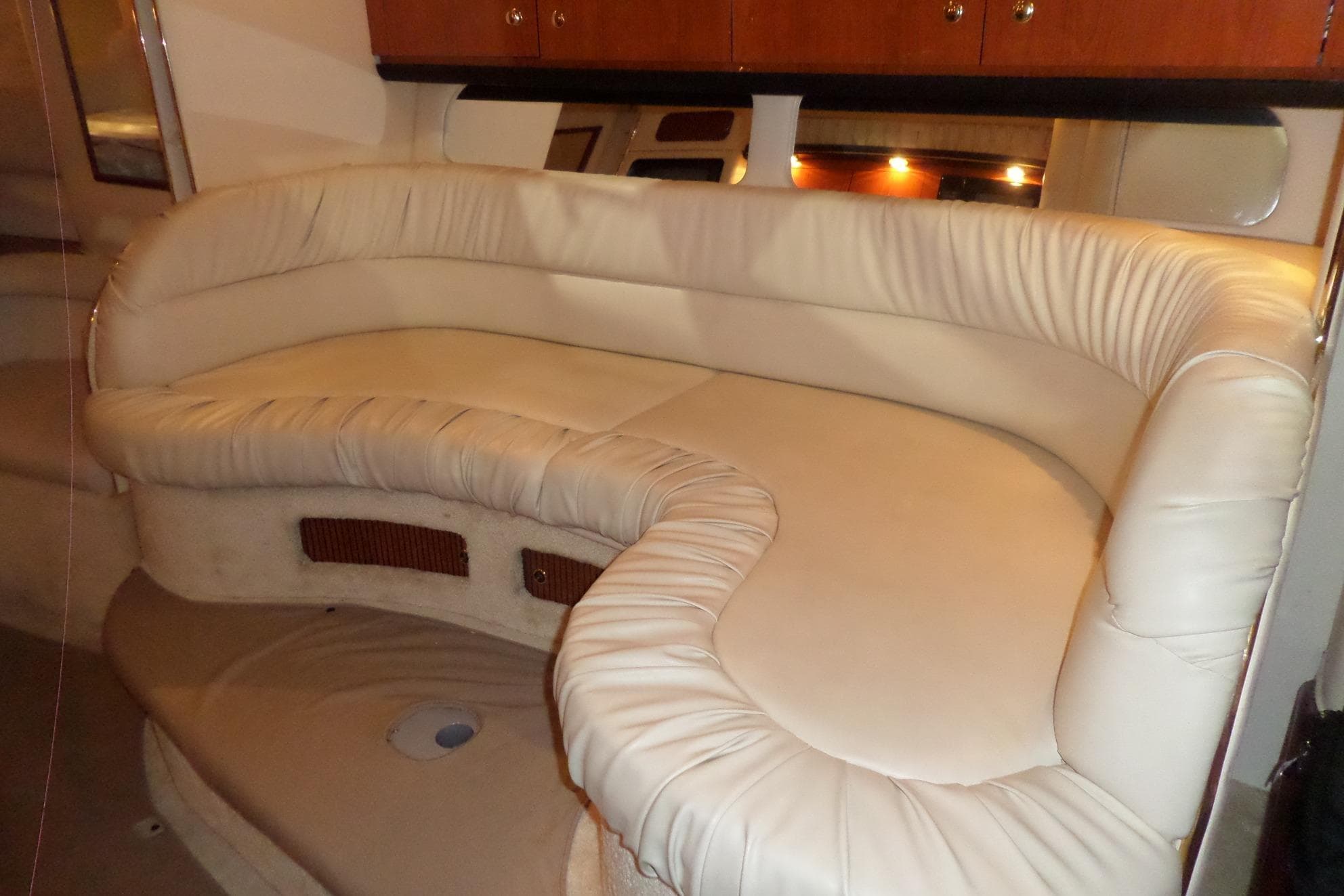 Interior of 2000 Sea Ray 340 Sundancer with plush cream seating.