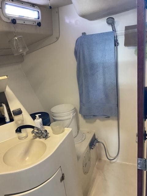 Compact bathroom in a 1994 Sundeer 56 yacht with shower and sink.