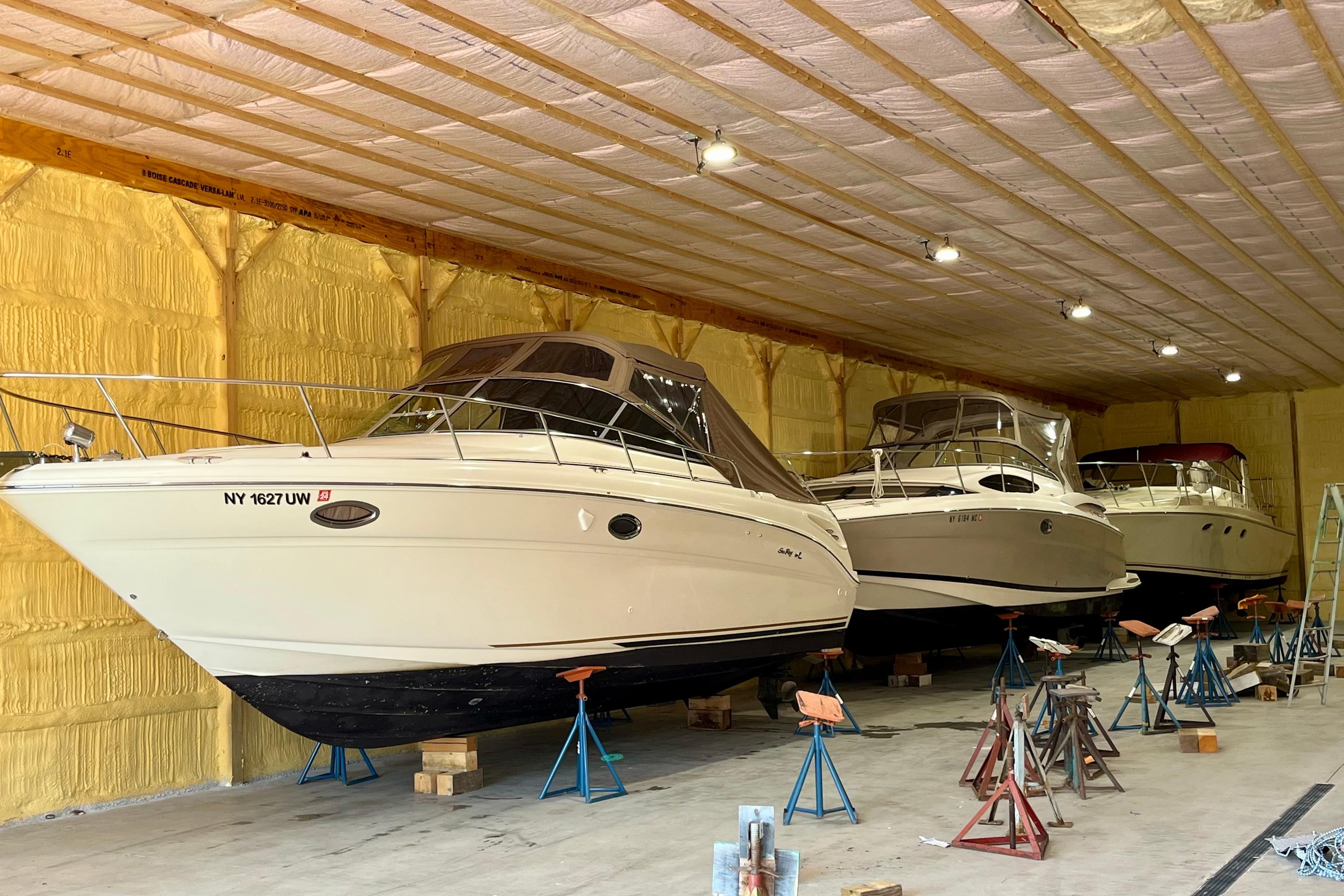 2000 Sea Ray 290 Amberjack boats stored indoors on stands.