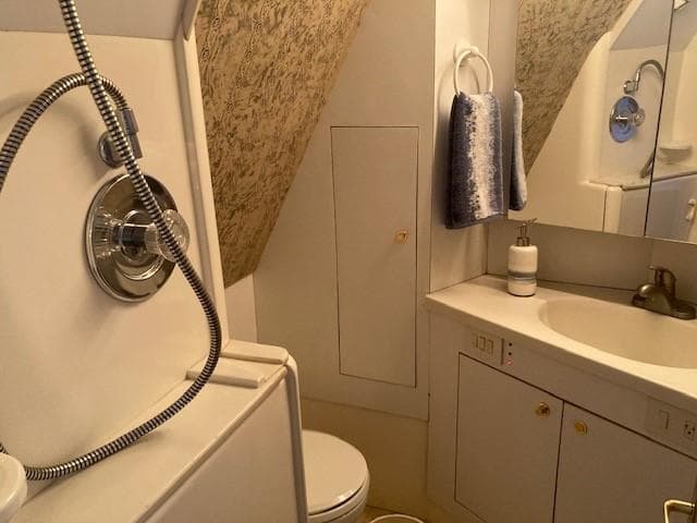 1998 Ocean Yachts 45 Super Sport bathroom with shower, sink, and toilet.