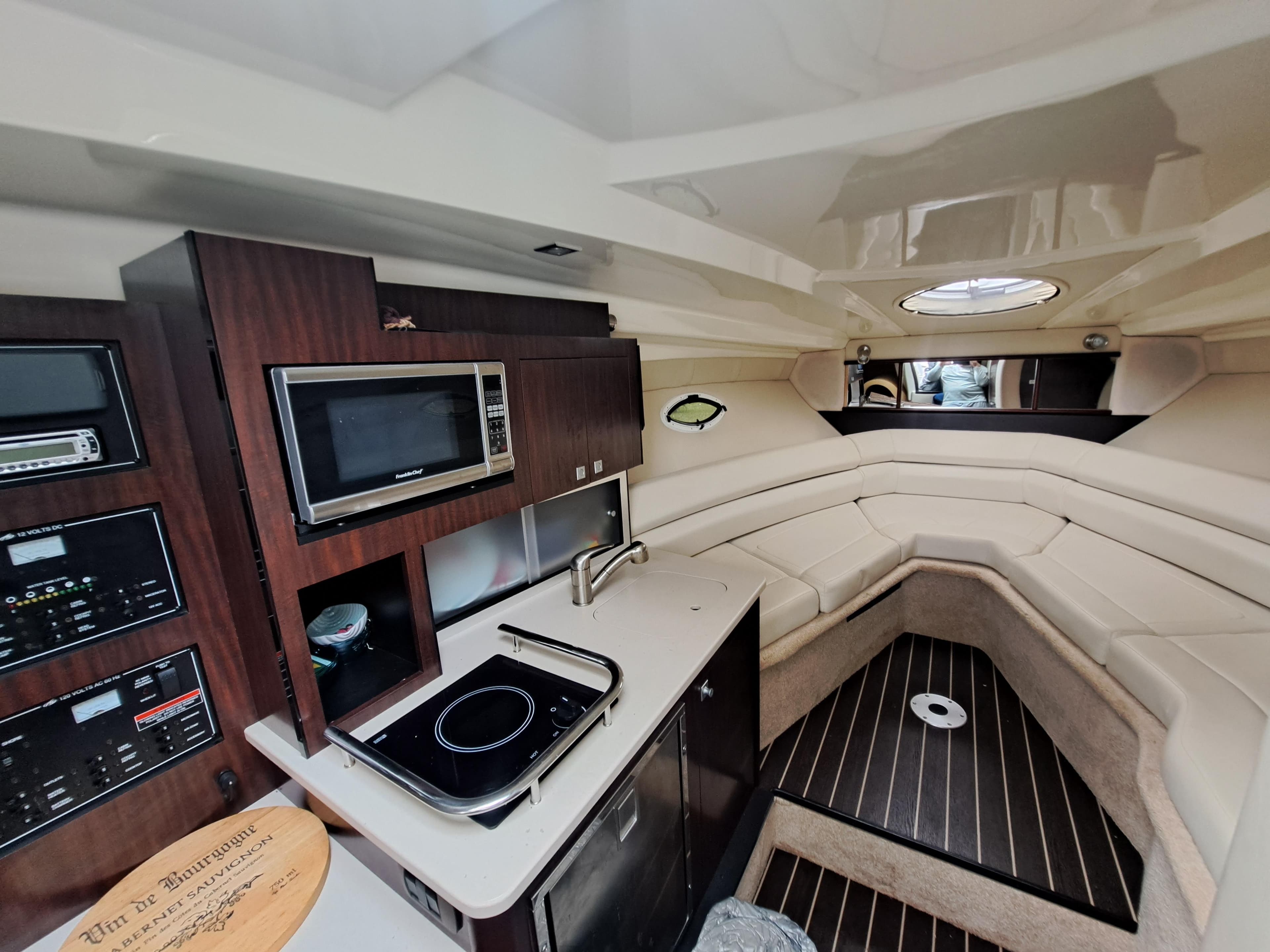 Interior of 2015 Monterey 295 Sport Yacht with kitchenette and seating area.