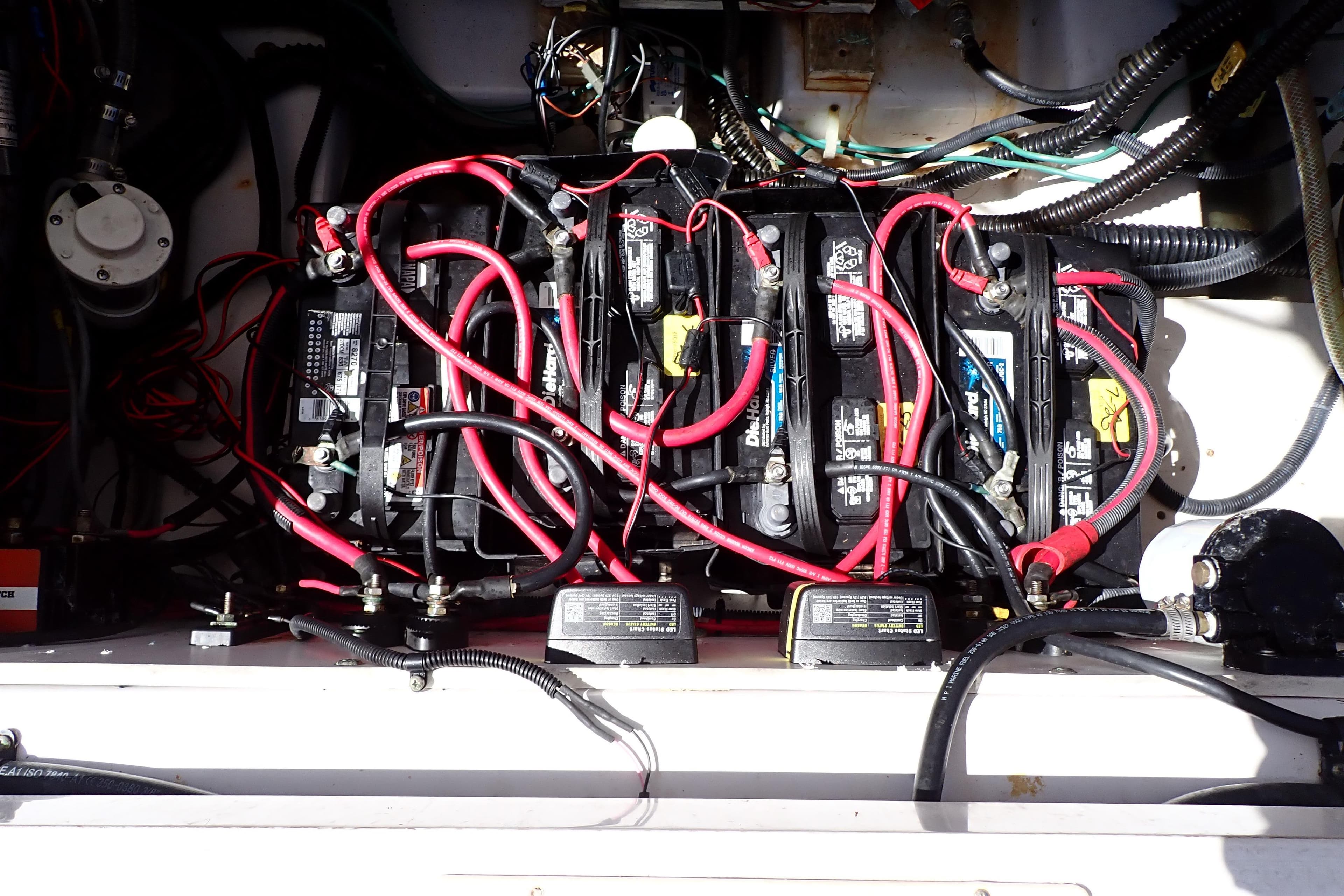 Battery compartment of 2014 Pro-Line 32 Express boat with red cables and wiring.