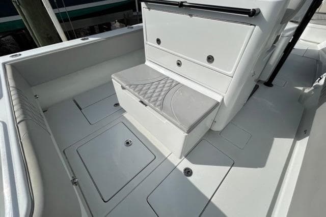 2023 Contender 32 ST boat interior with cushioned seating and storage compartments.