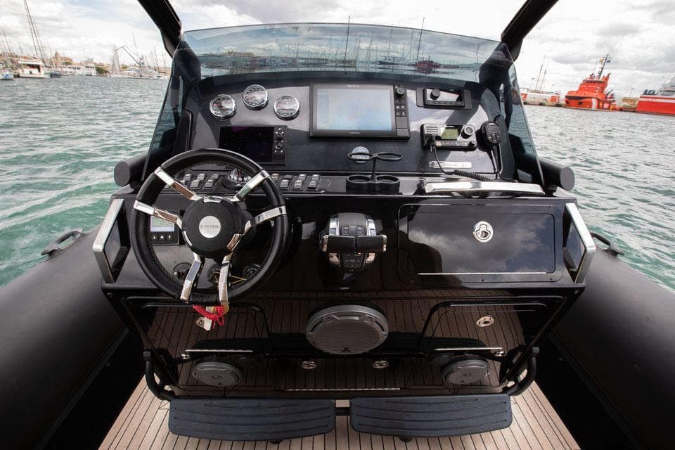 Cockpit of 2017 Ribco Seafarer 36 boat with steering wheel and navigation instruments.
