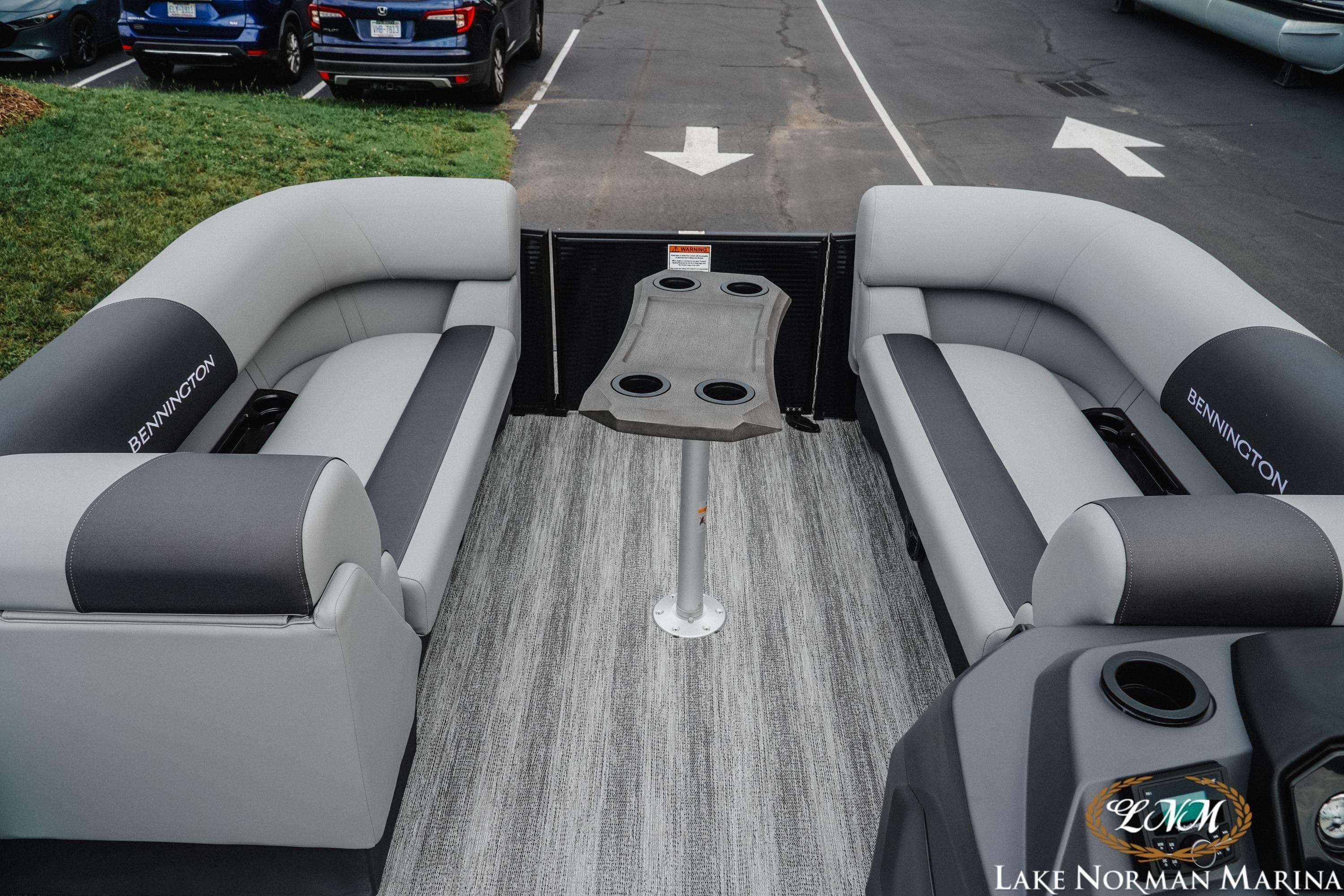2026 Bennington 22SSR pontoon boat interior with gray seating and central table.