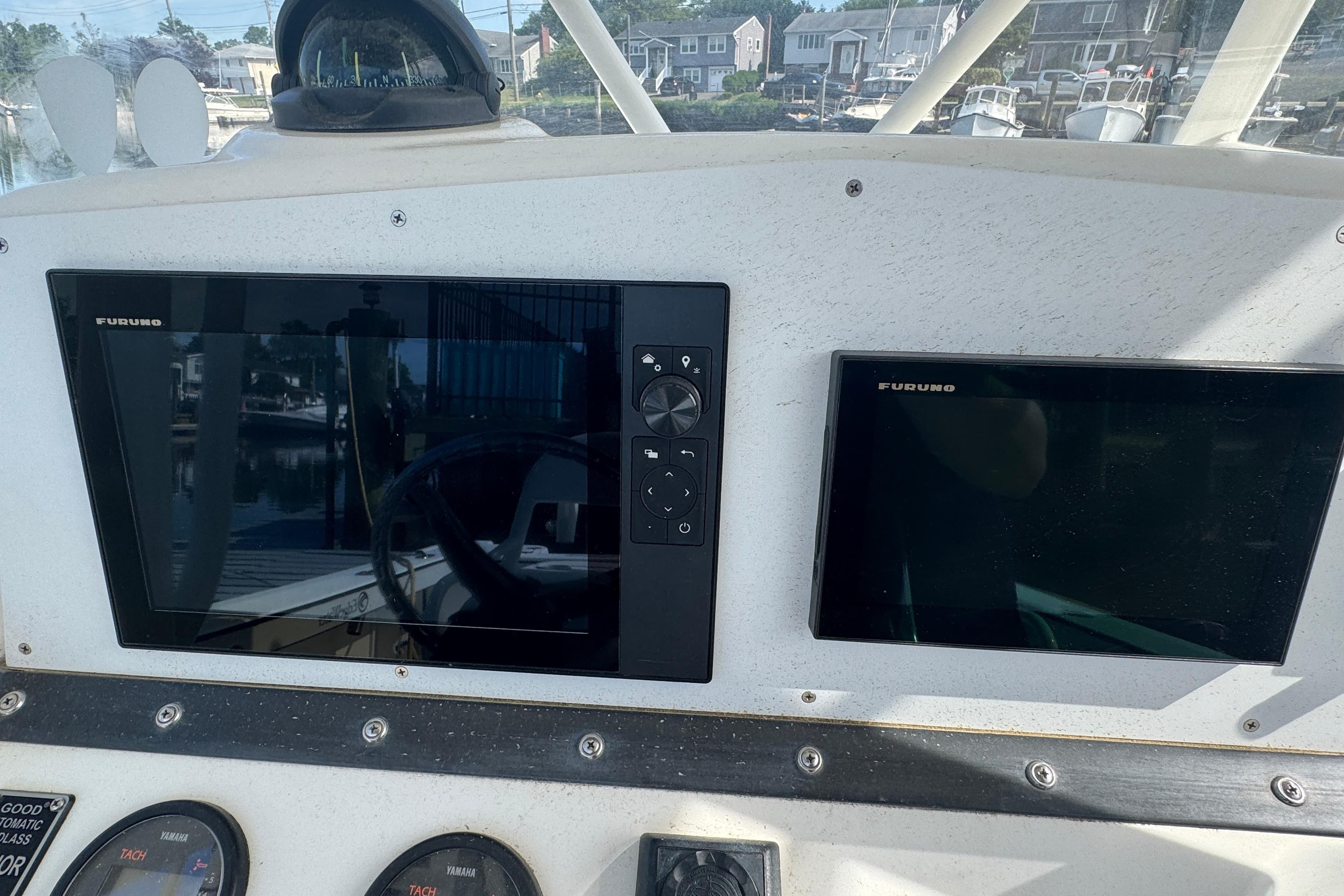 Dashboard of a 2005 Edgewater 265CC boat with Furuno navigation displays.