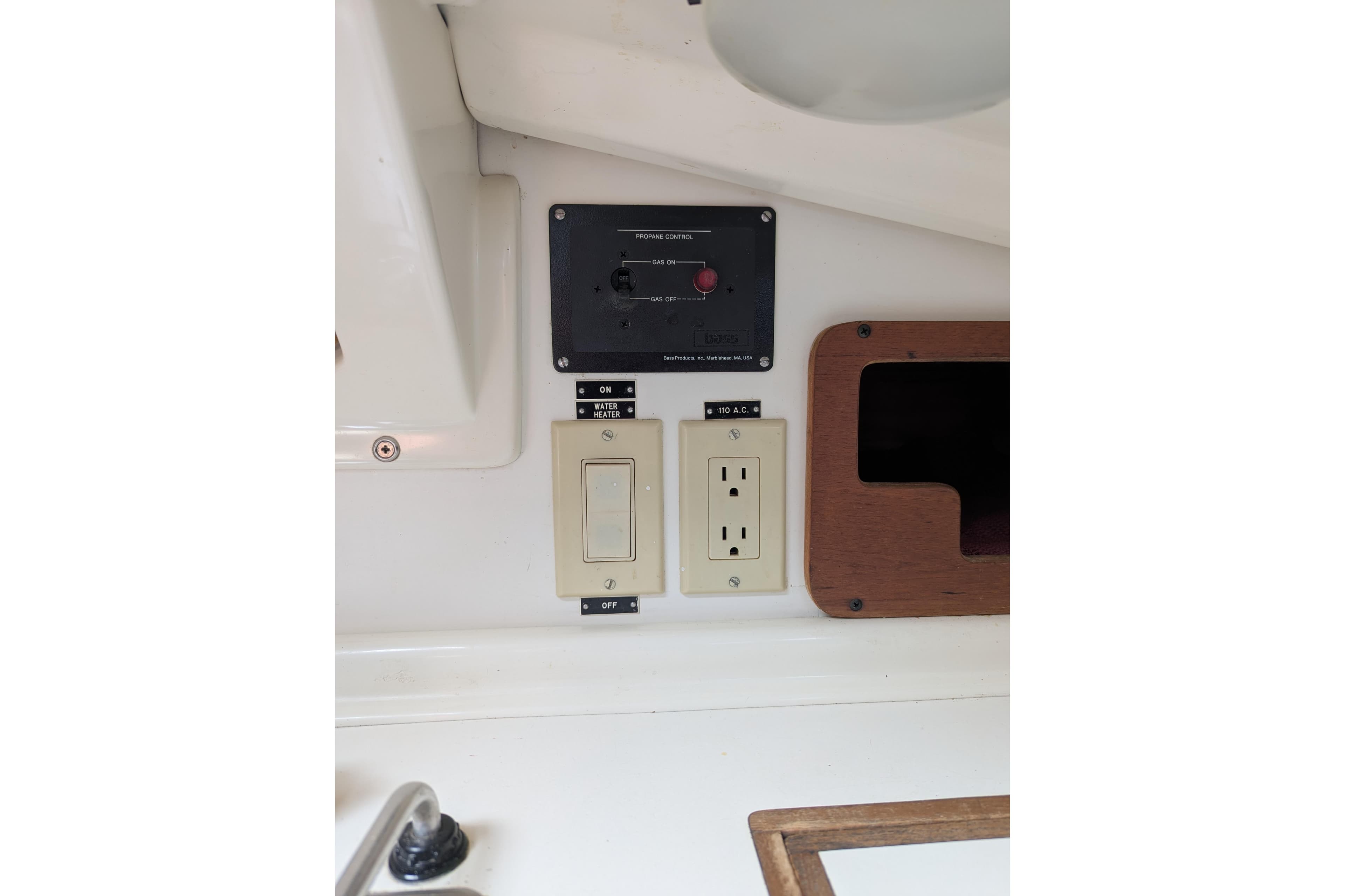 Electrical panel and outlet on a 1982 Pearson 323 sailboat interior.