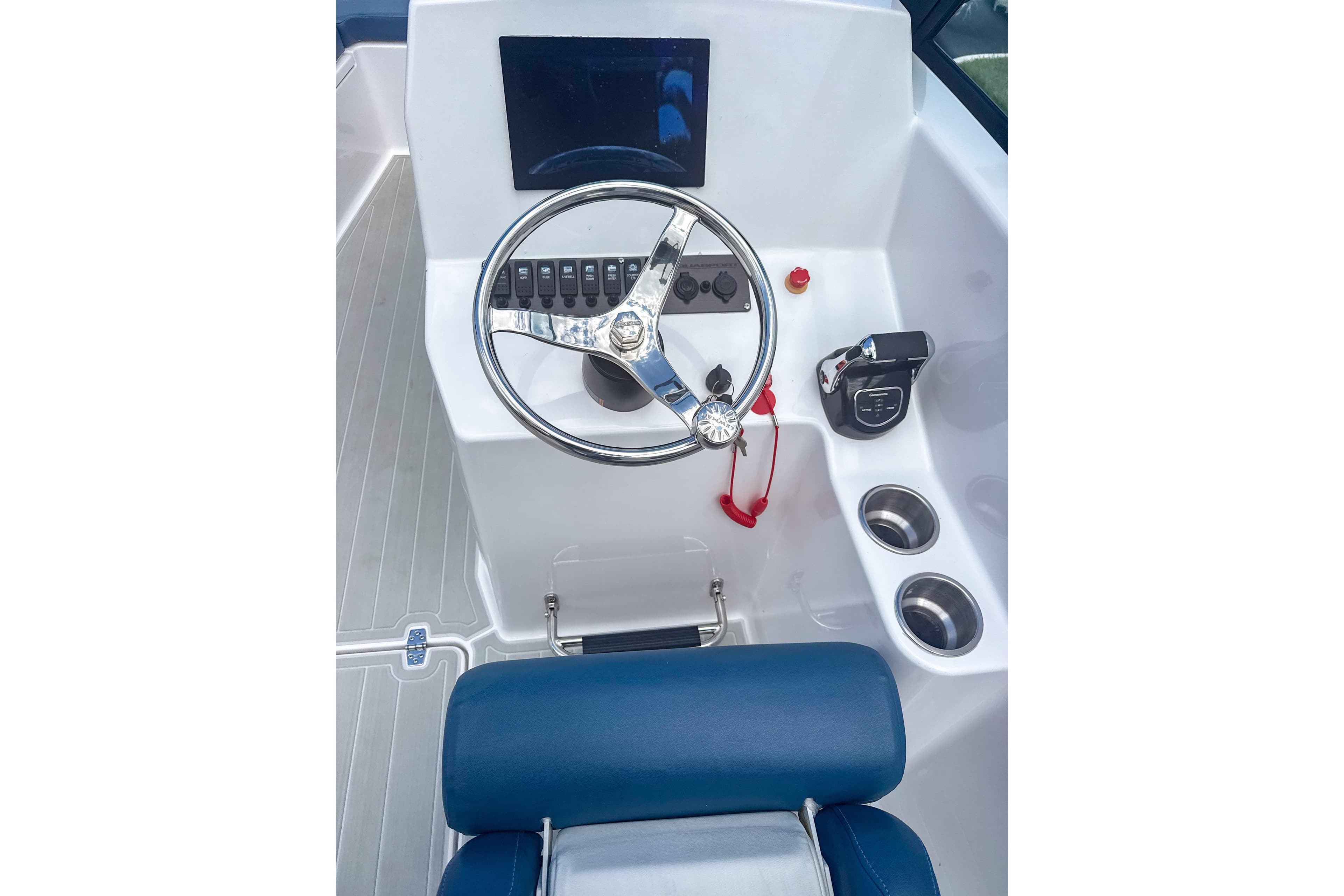 2024 Aquasport AS DC 22 boat dashboard with steering wheel and controls.