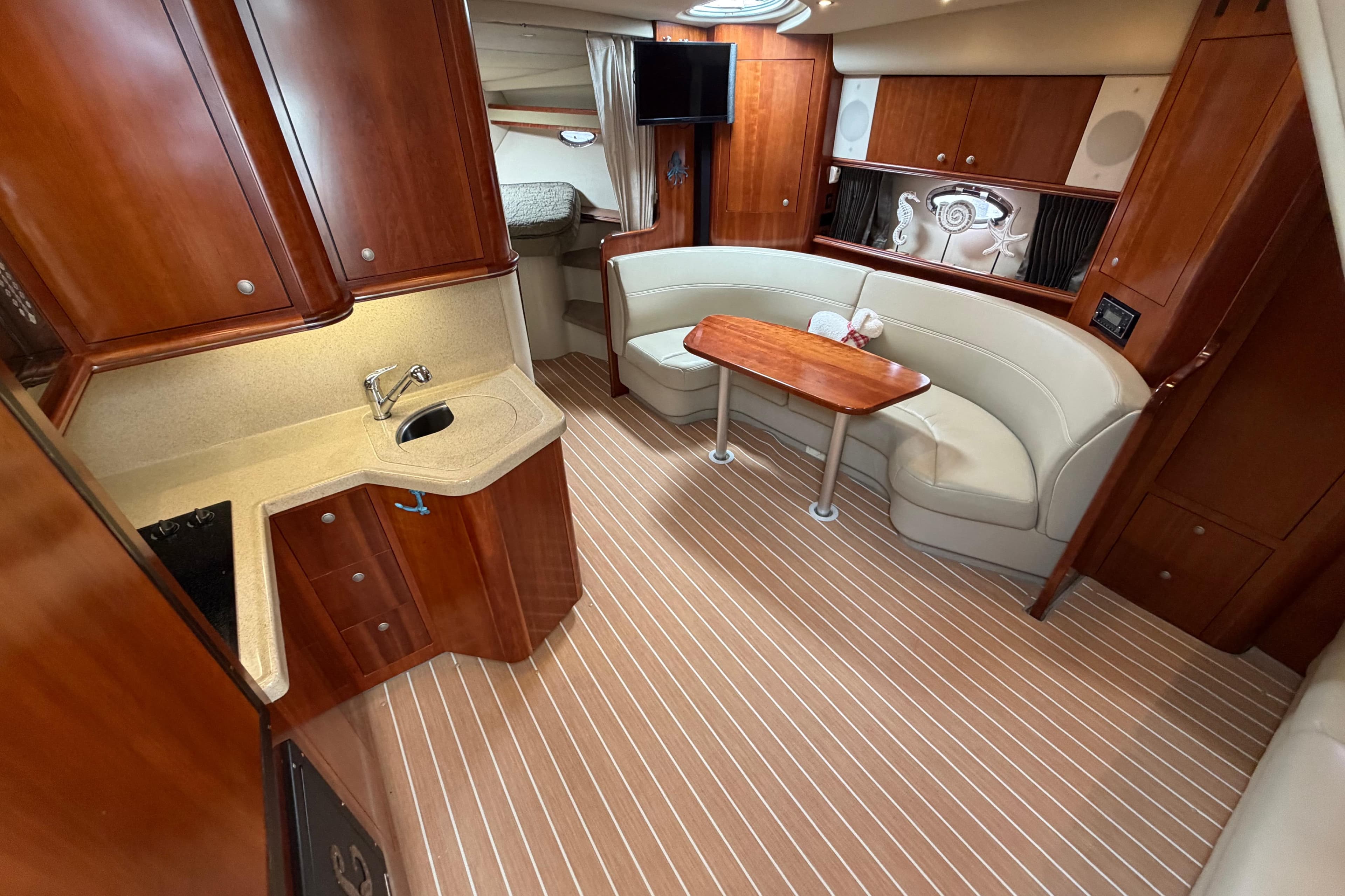 Luxurious interior of 2007 Cruisers Yachts 370 Express with elegant wood cabinetry and plush seating.