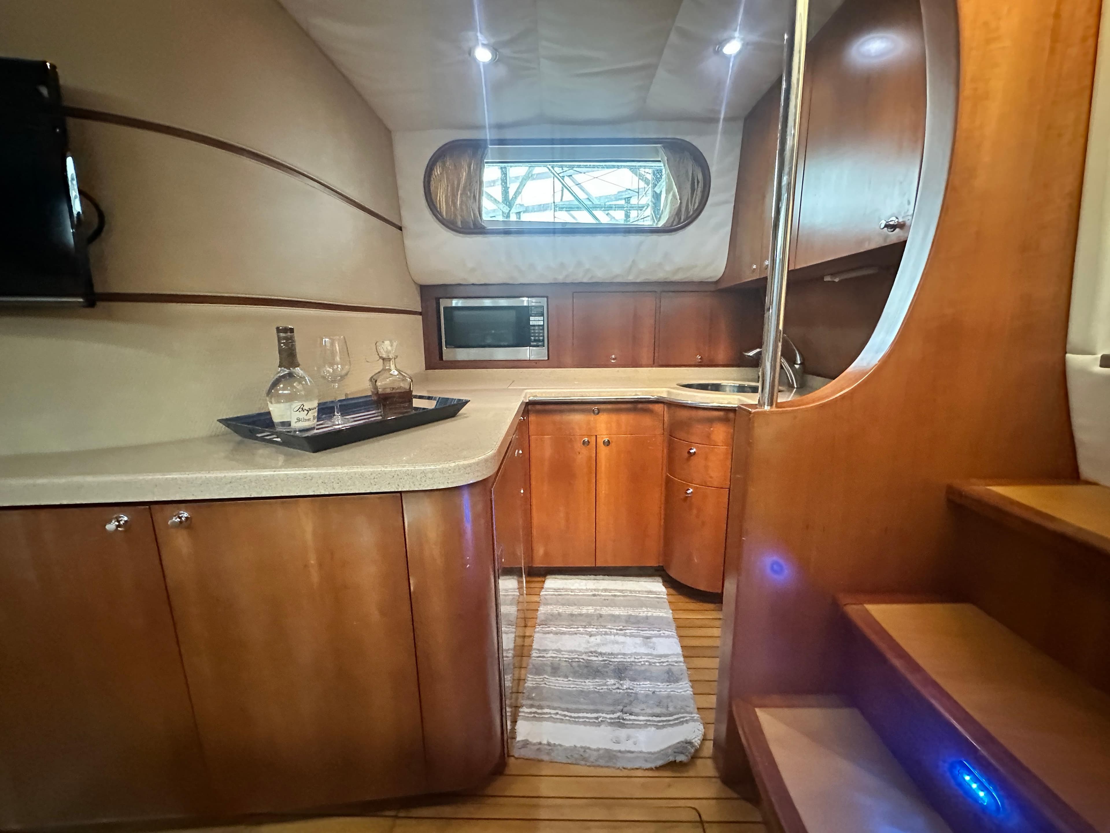 Luxurious 2007 Chris-Craft Roamer 40 yacht interior with modern kitchen and wooden cabinetry.