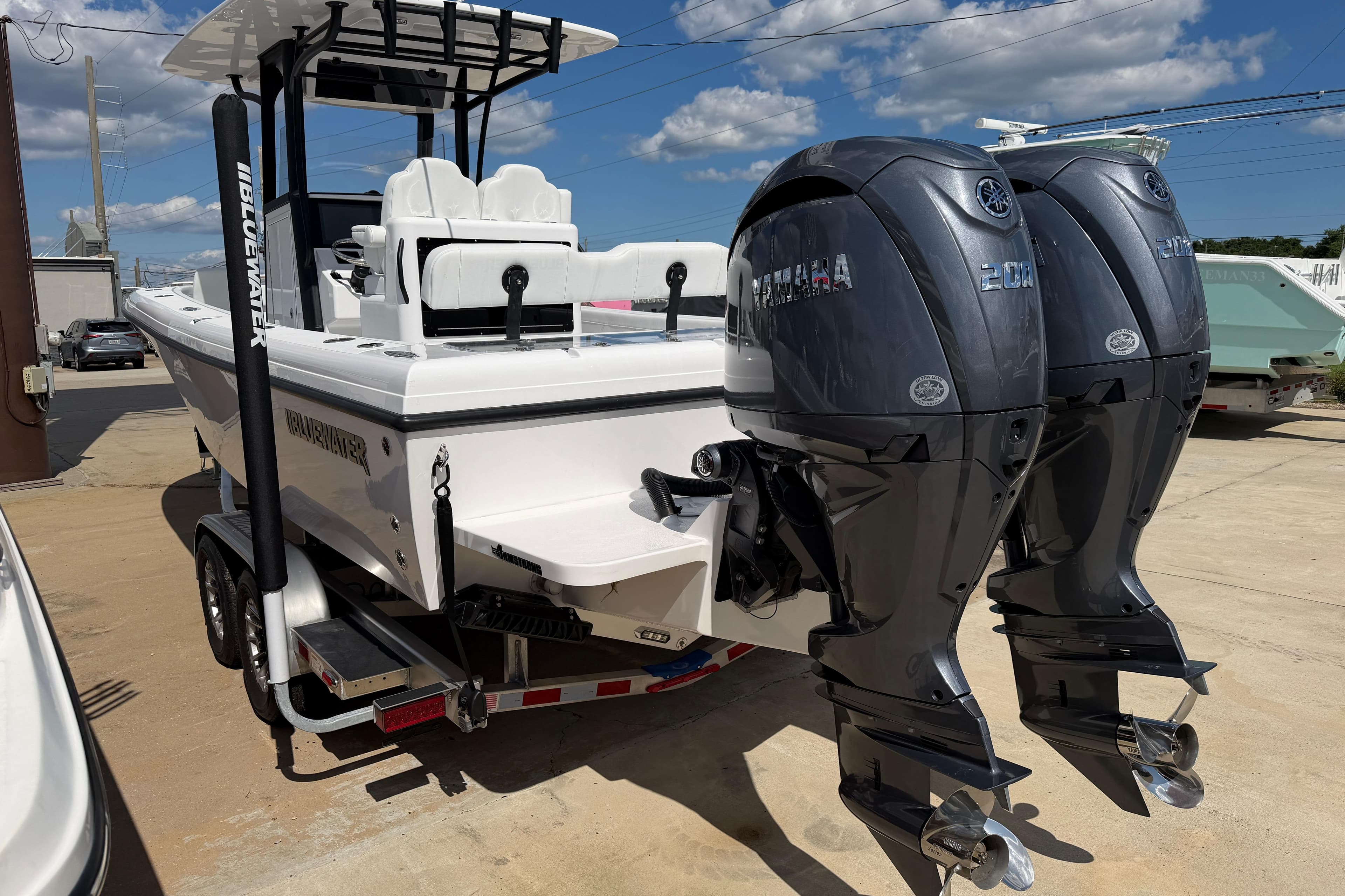2026 Bluewater Sportfishing 25T boat with dual Yamaha engines on a trailer.