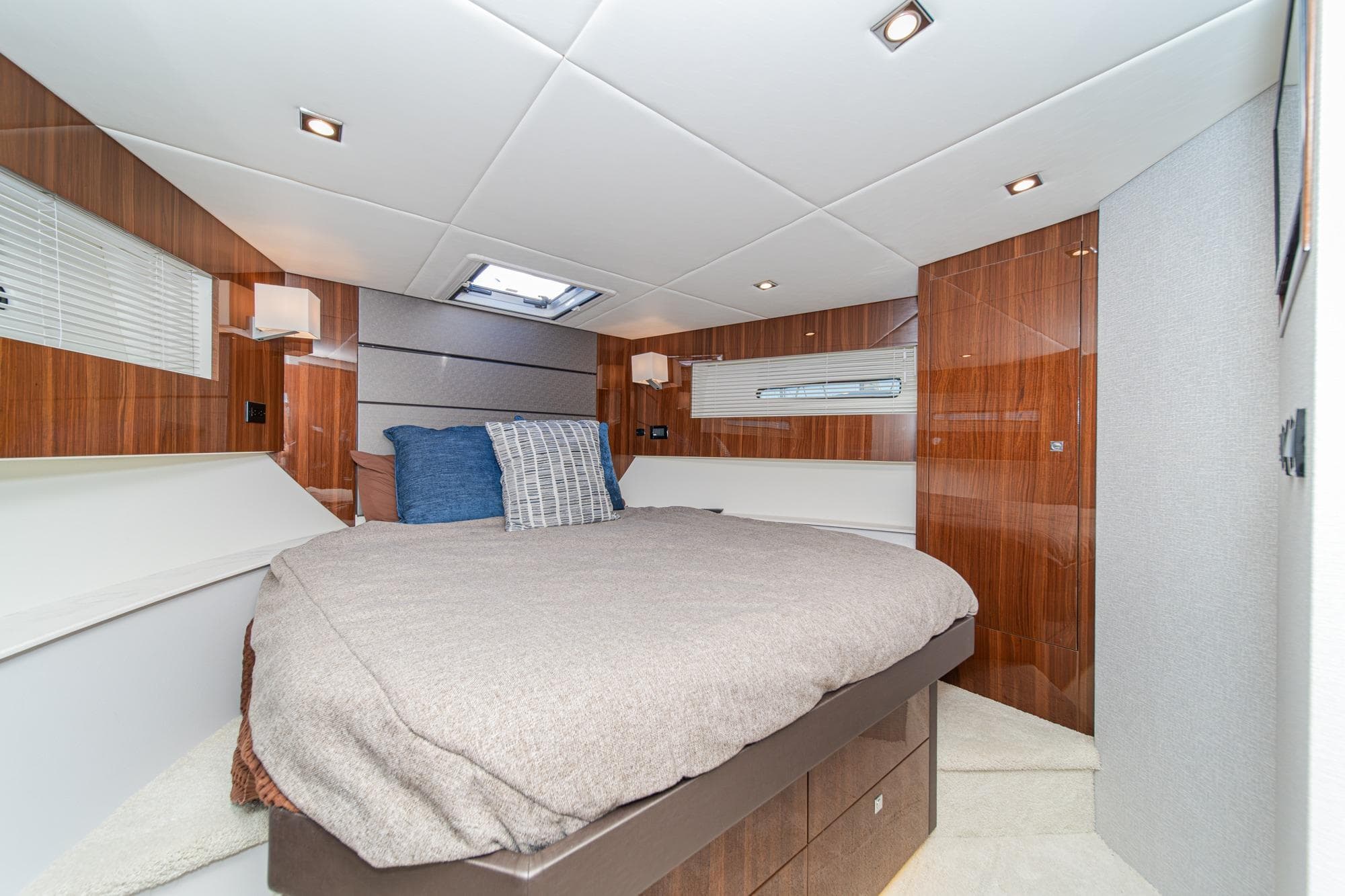 Luxurious bedroom interior of 2023 Cruisers Yachts 42 Cantius with modern design and cozy bedding.