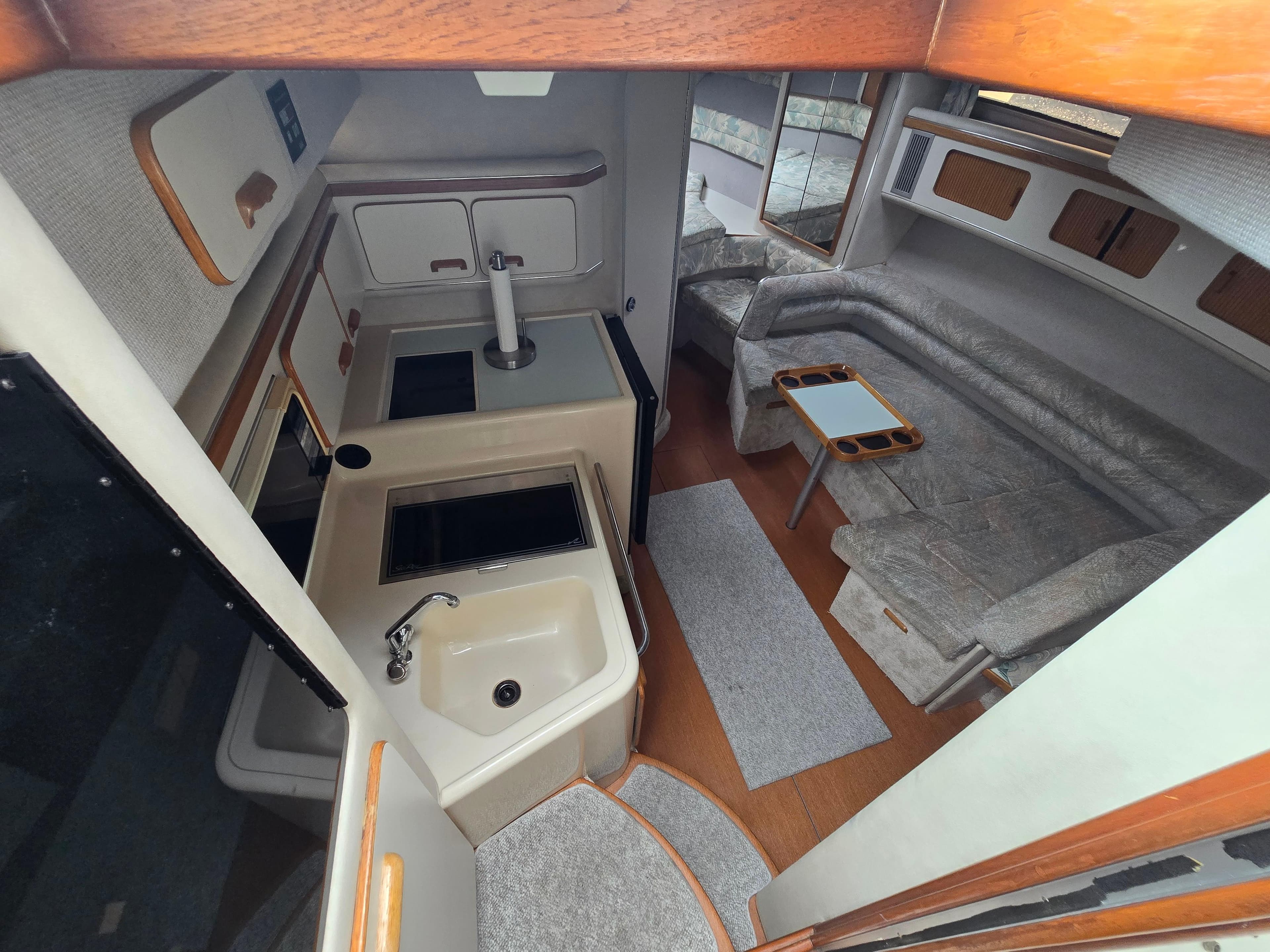 Interior of 1993 Sea Ray 330 Express Cruiser with kitchen and seating area.
