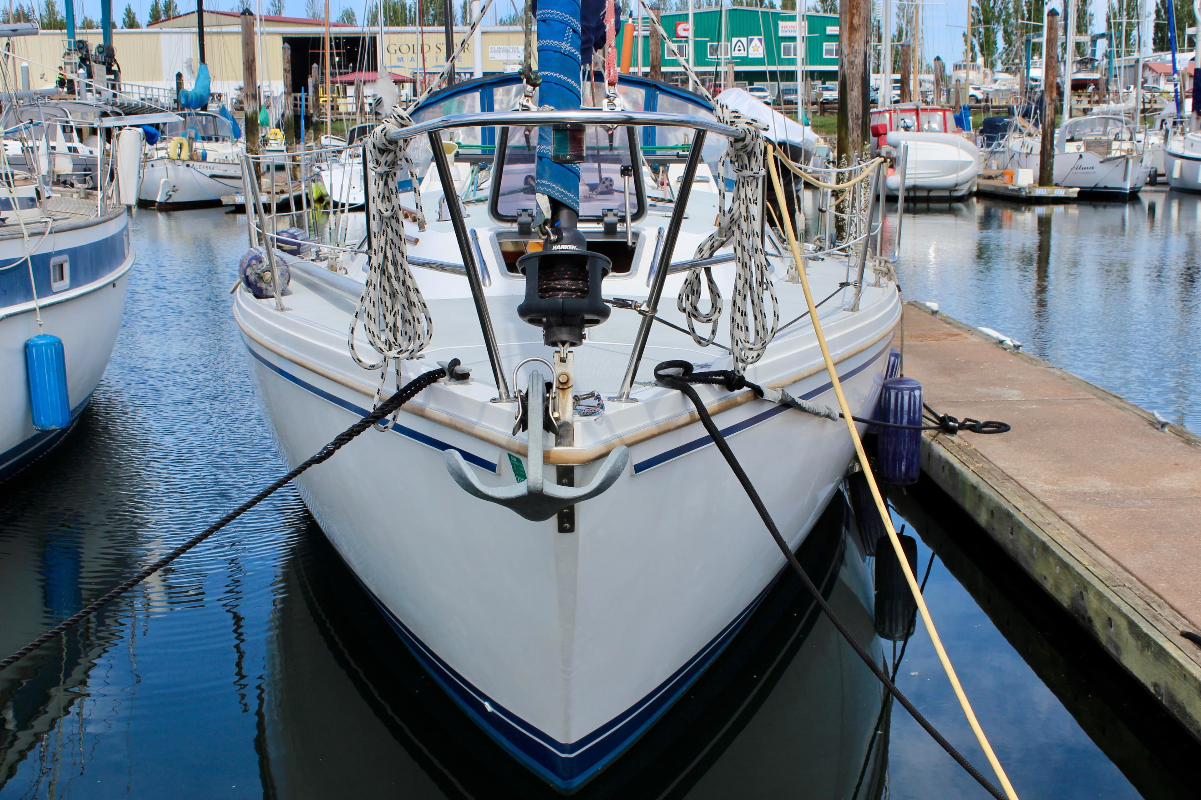 1989 Catalina 36 sailboat docked in a marina, front view.