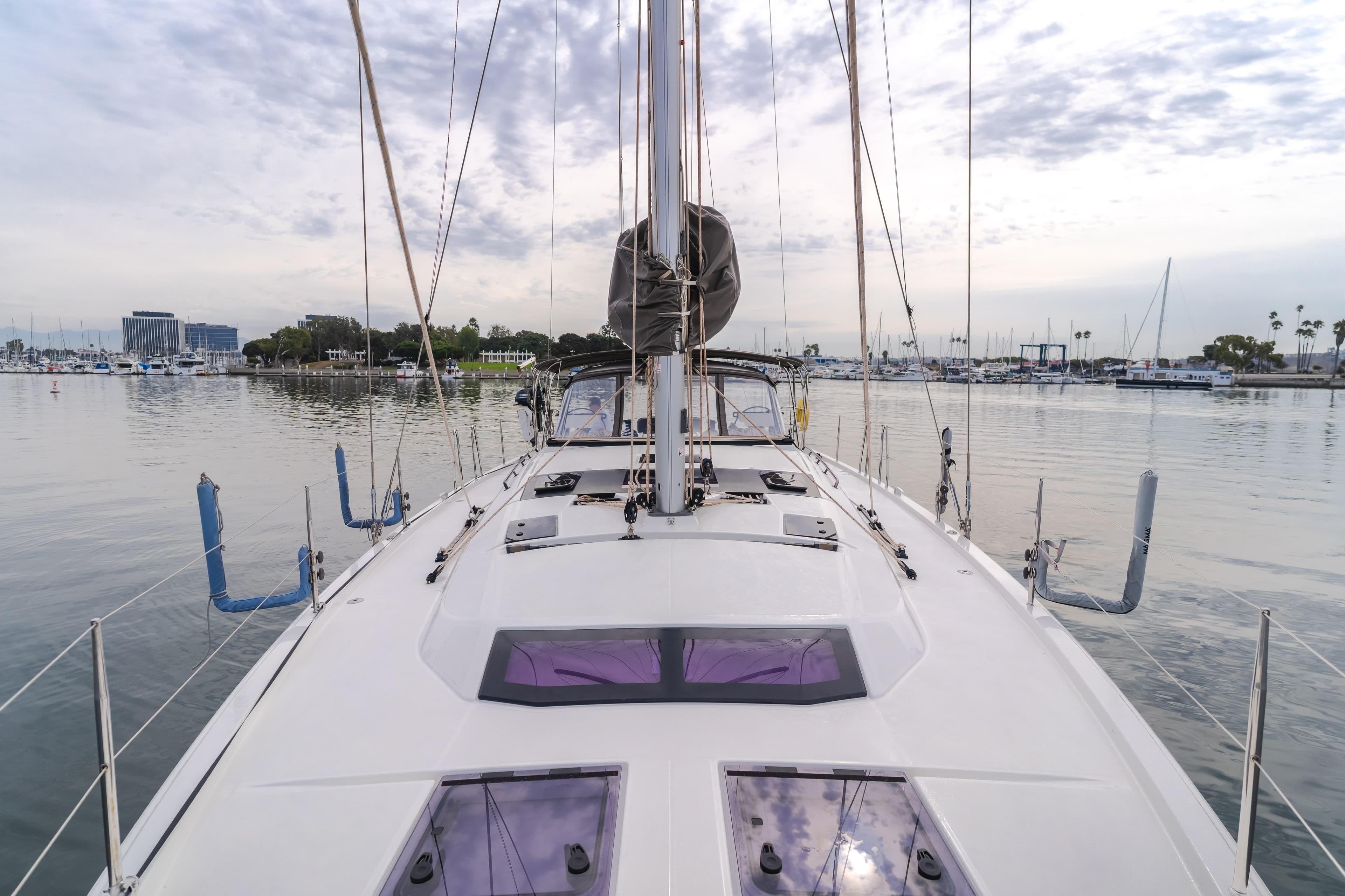 2024 Dufour 470 sailboat docked in a calm marina, showcasing sleek deck design.
