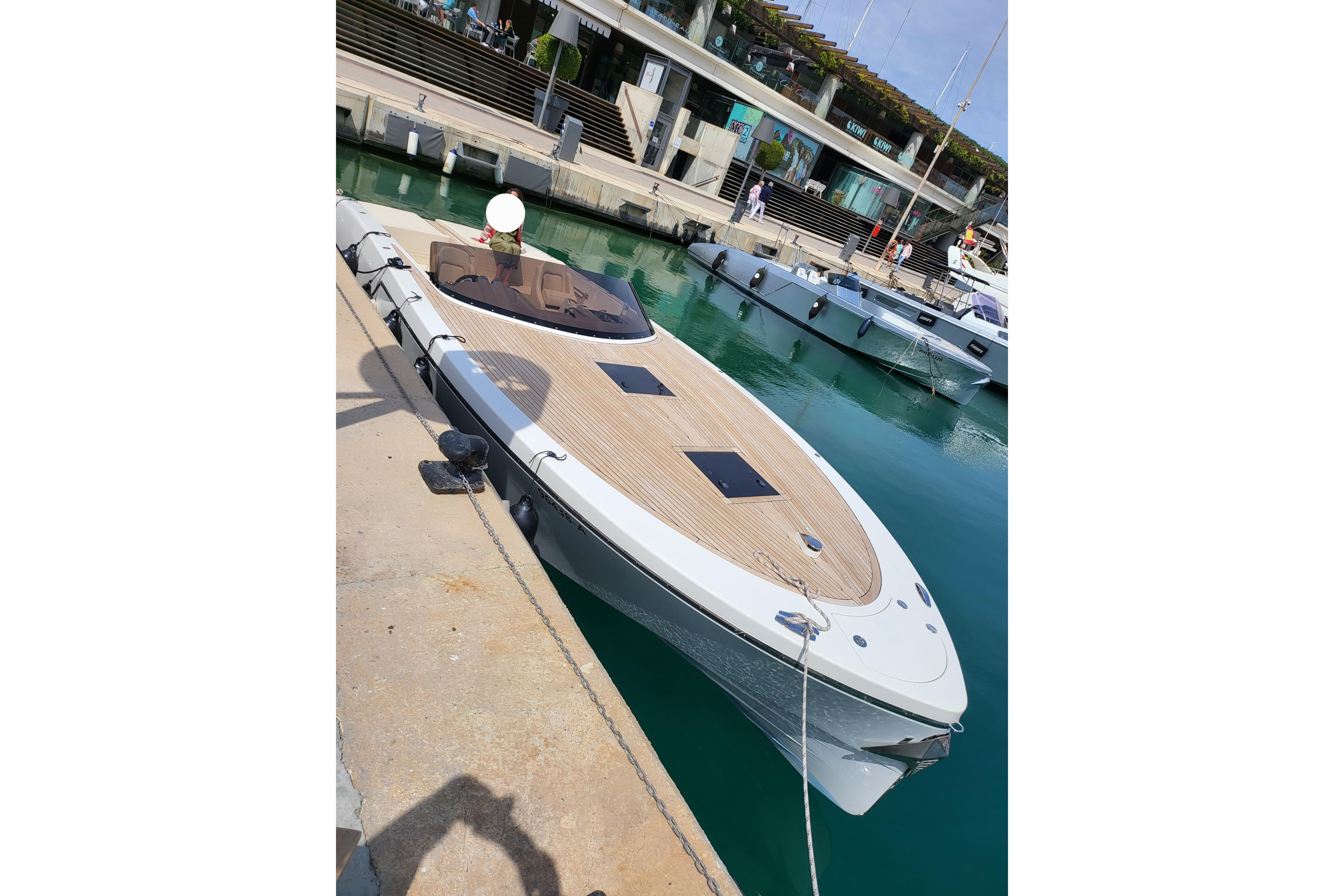 2019 Frauscher 1017 GT luxury boat docked at marina with sleek design.