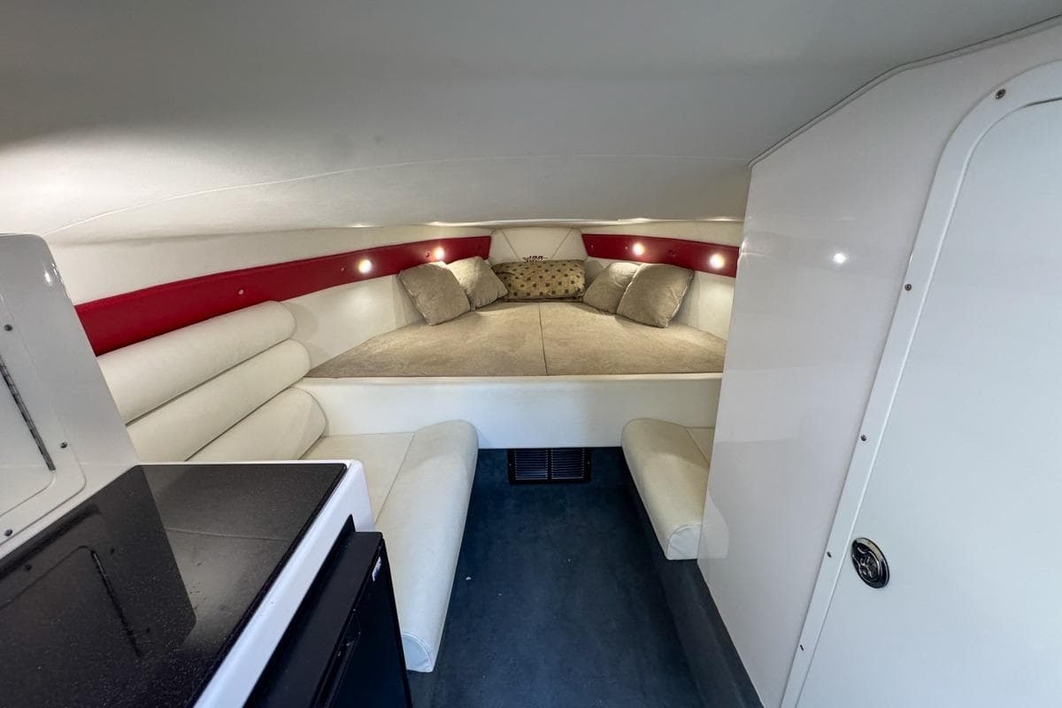 2022 Velocity 290sc boat interior with cozy cabin, cushioned seating, and ambient lighting.