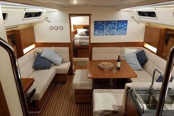 Luxurious interior of 2016 Hanse 455 yacht with cozy seating and elegant decor.