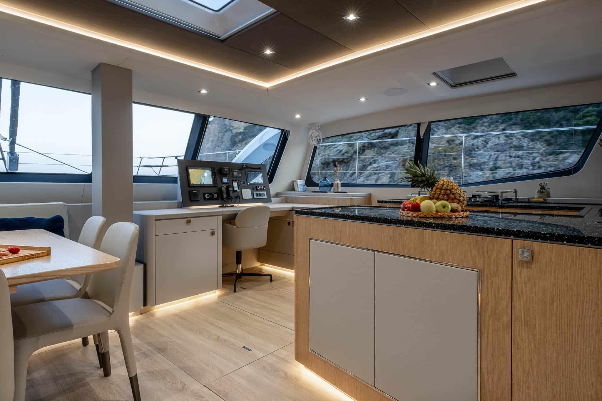 Luxurious interior of 2025 Privilege Signature 580 yacht with modern kitchen and dining area.