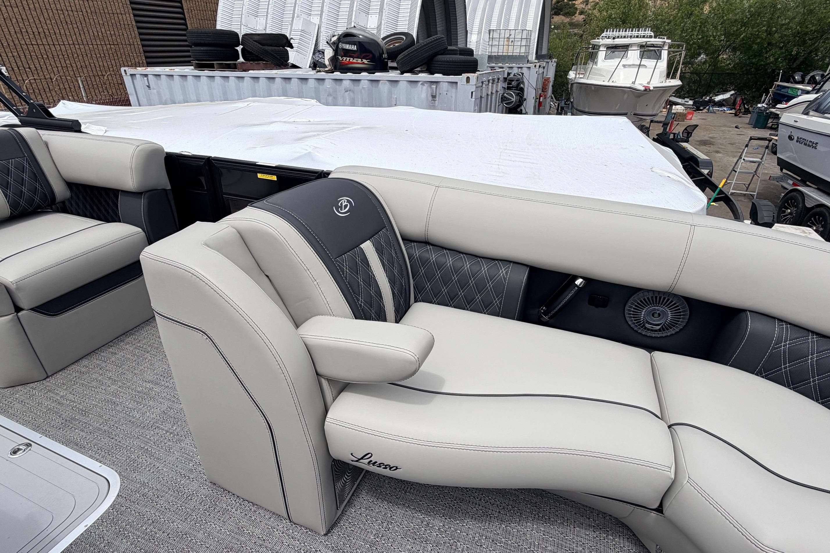 Luxurious seating on 2026 Barletta Lusso 23M pontoon boat, featuring elegant upholstery and design.