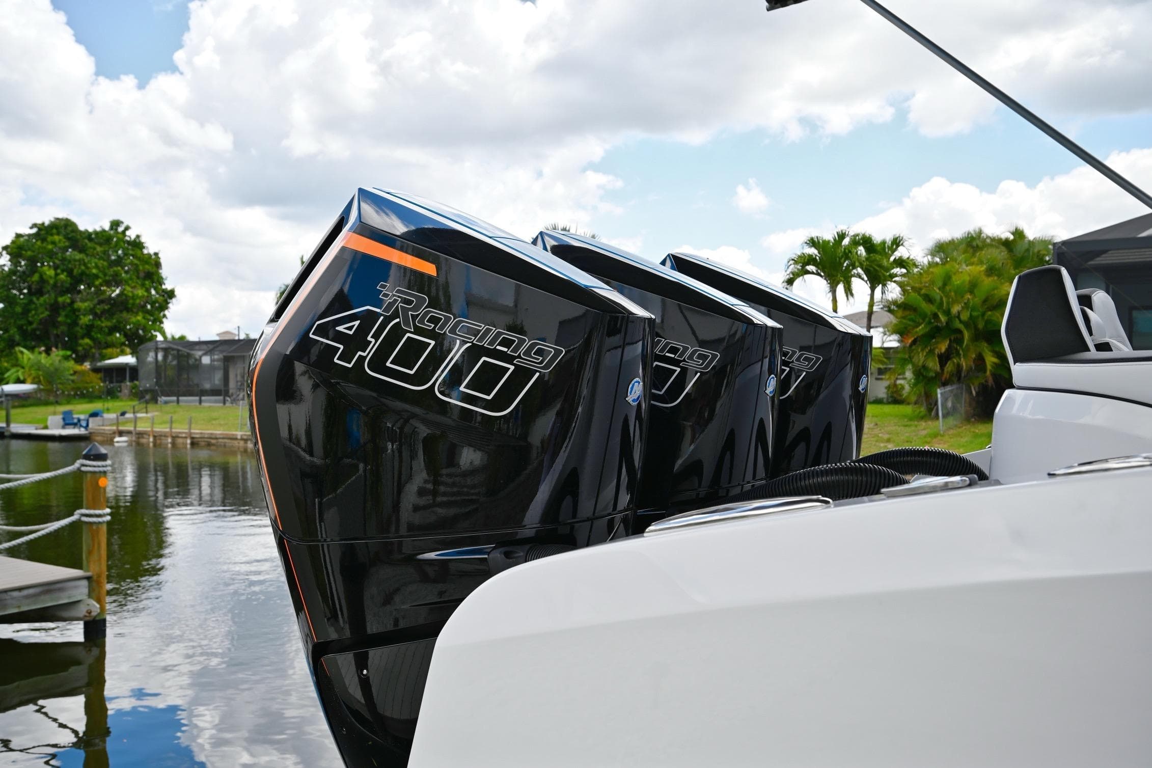 Renegade 38' Open 2027 boat with triple Racing 400 engines docked by water.
