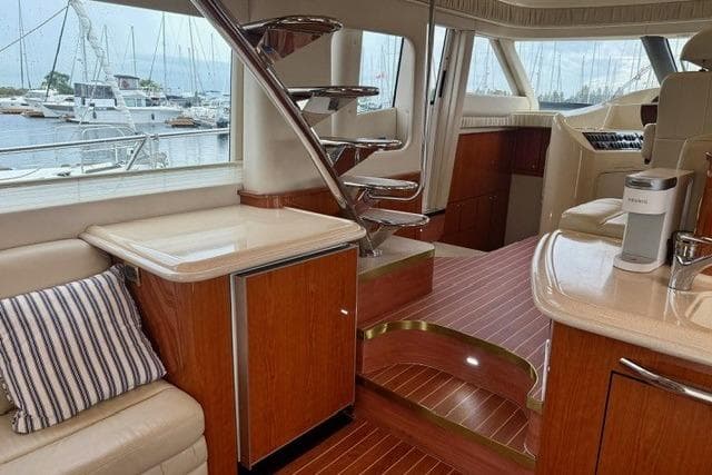 Luxurious interior of 2001 Sea Ray 540 Cockpit Motor Yacht with elegant wood finishes.