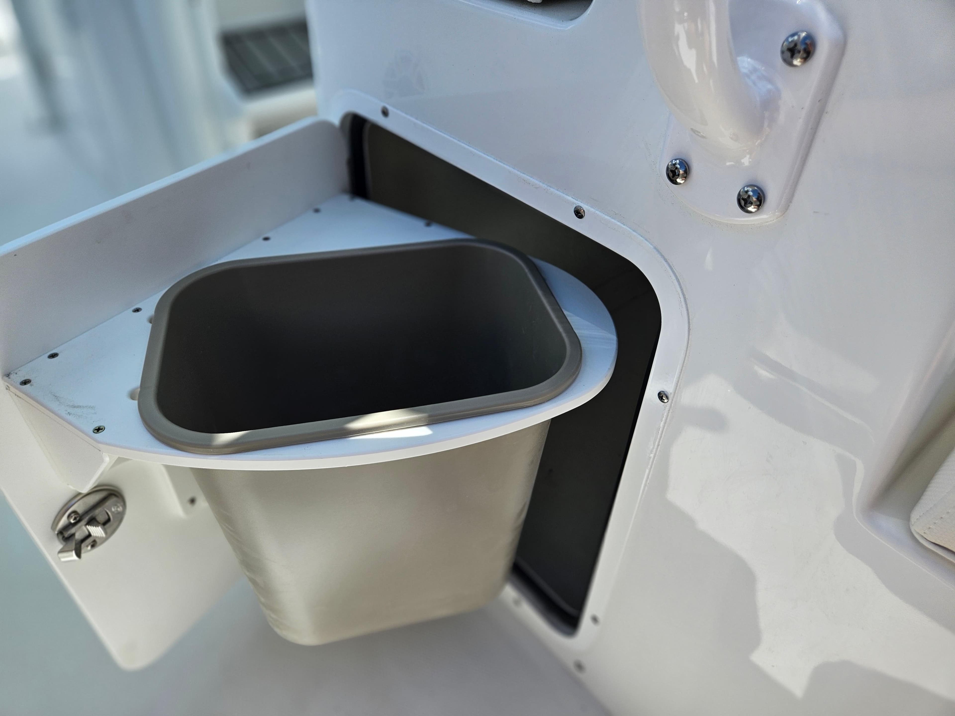 Built-in trash compartment on 2026 Sea Hunt Ultra 275 SE boat.