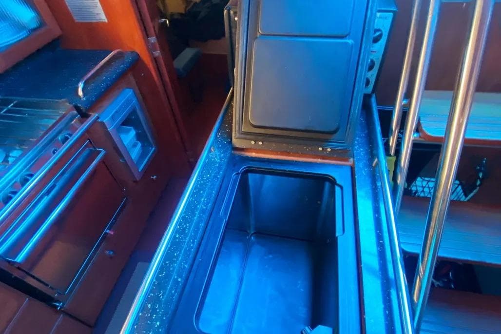 Interior of 2012 Hunter Aft Cockpit 50 yacht kitchen with open storage compartment.