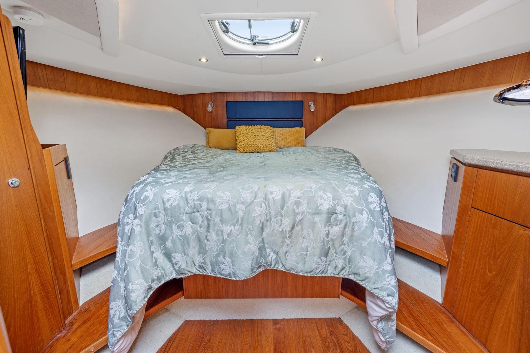 Luxurious cabin interior of 2012 Tiara Yachts 3100 Coronet with elegant bedding.