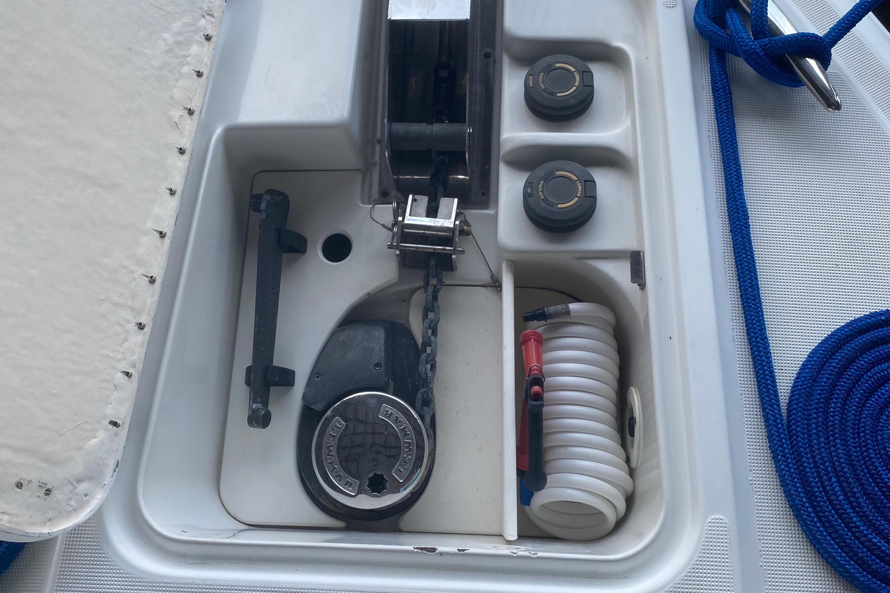 Boat anchor compartment with chain, hose, and blue rope on a 2005 Formula vessel.