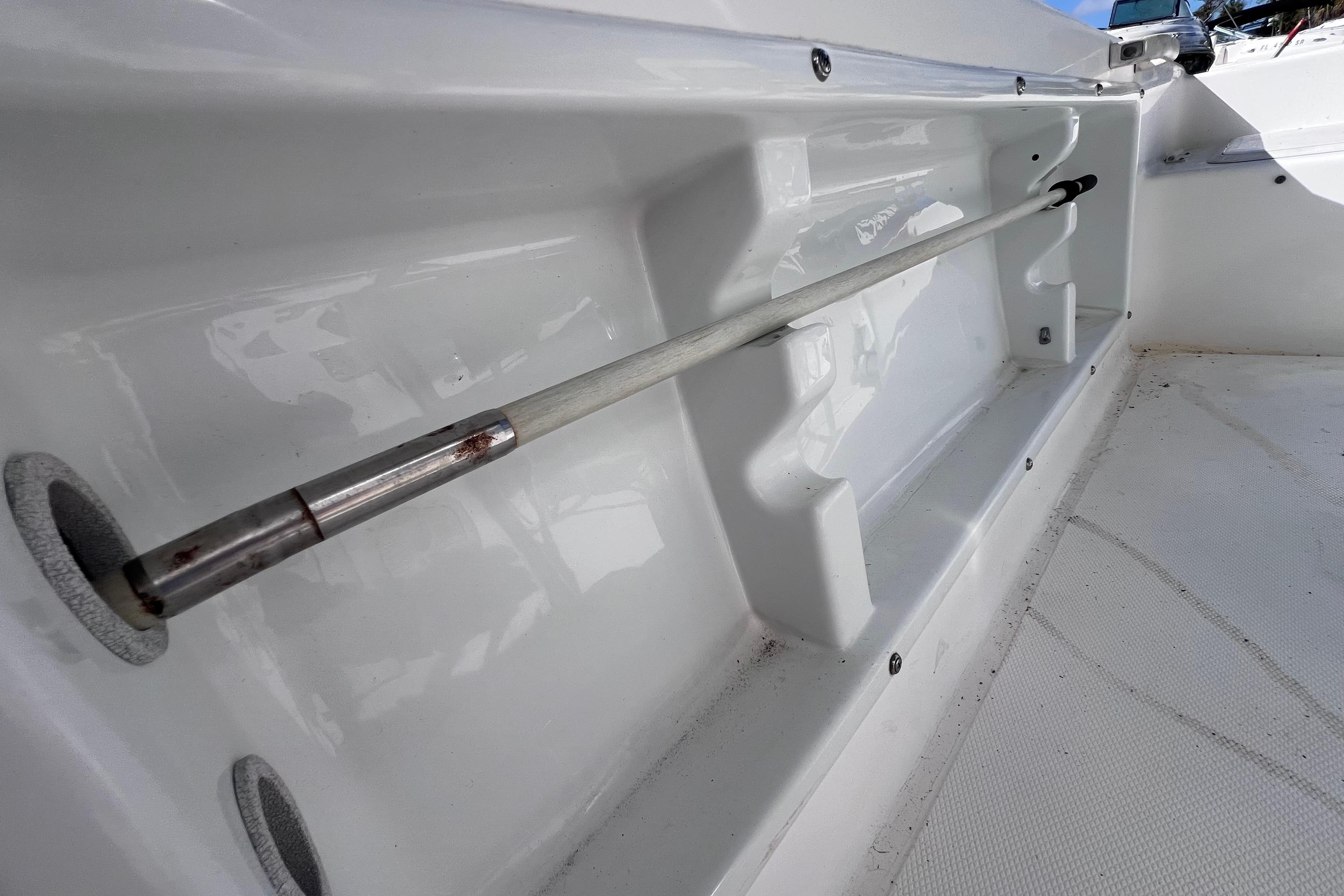 2001 Cobia 194 Center Console boat interior with rod holder detail.
