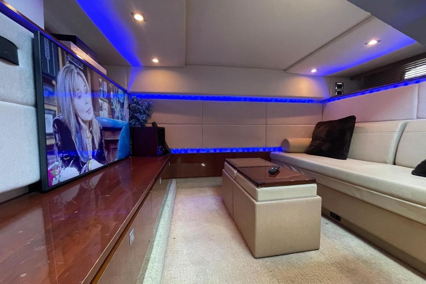 Luxurious interior of 2010 Sea Ray 450 Sundancer yacht with modern entertainment system.
