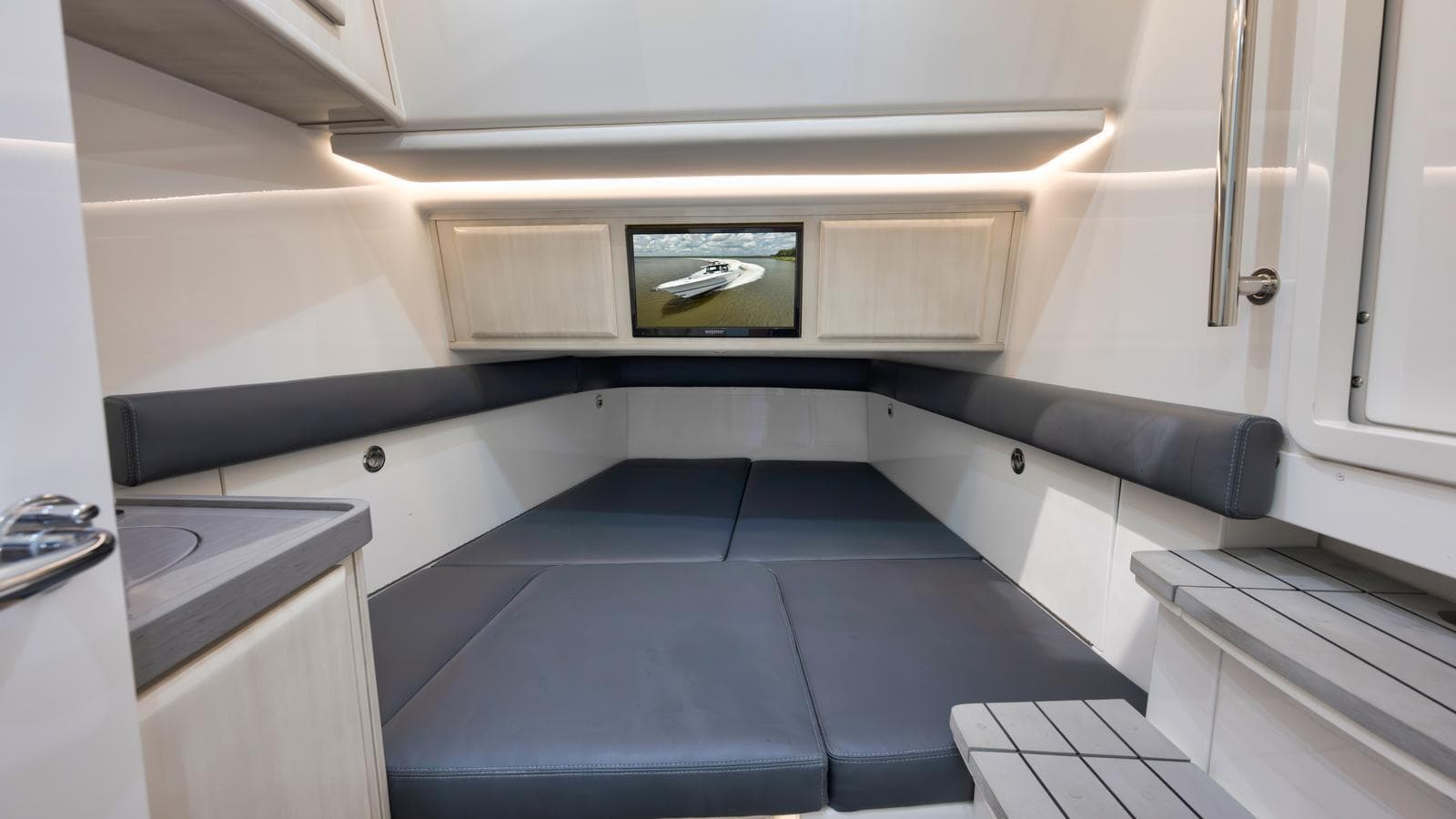 2021 HCB Suenos cabin interior with seating and TV, featuring modern design and lighting.