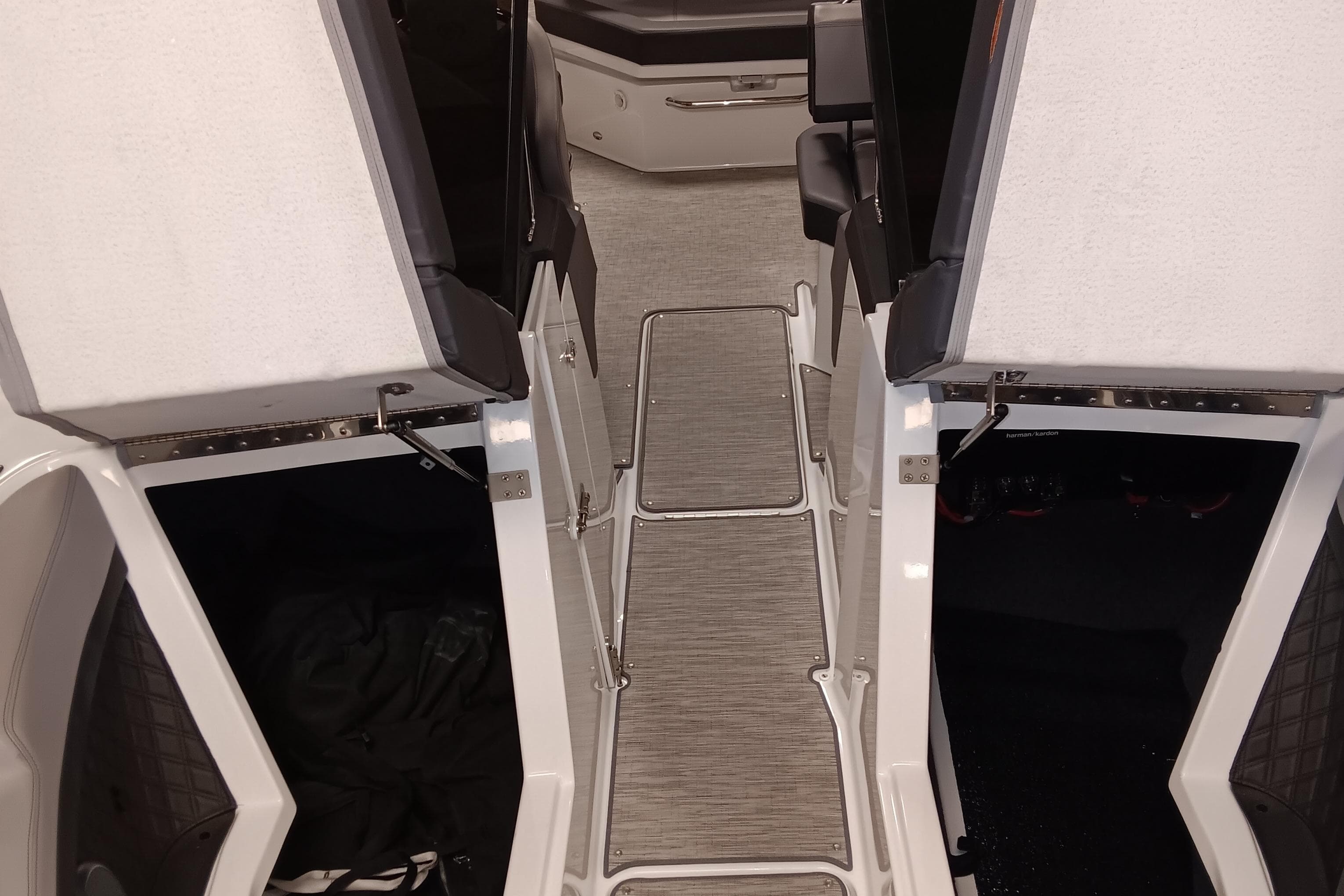 Interior view of 2023 Cobalt R4 boat, featuring open storage compartments and sleek flooring.