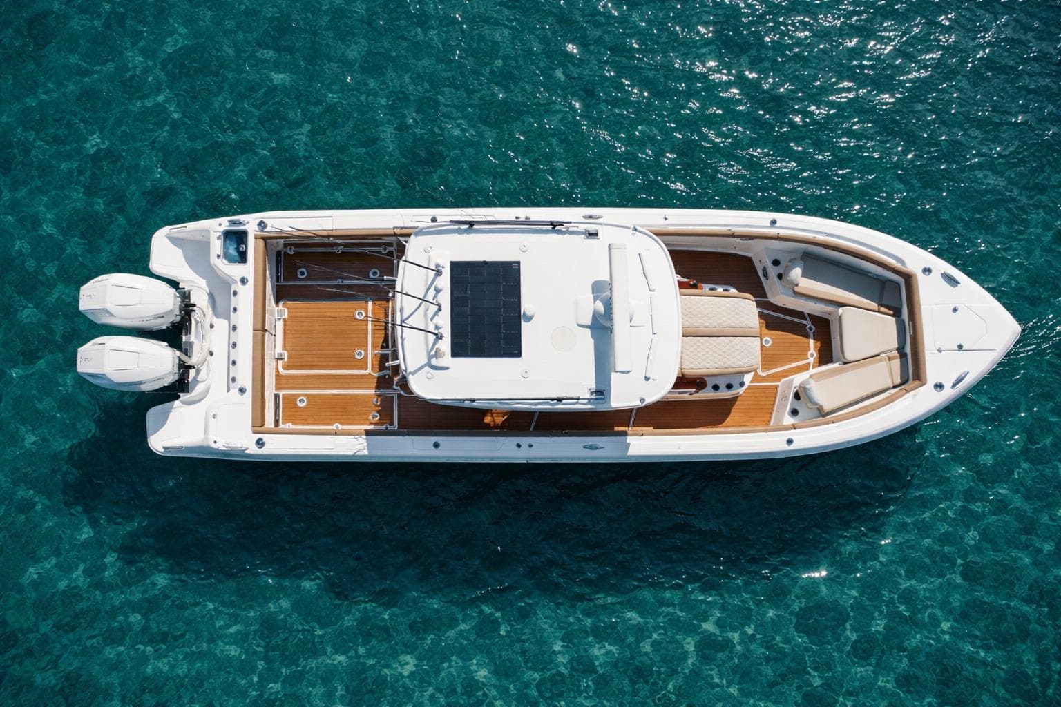 2024 Everglades 315 Center Console boat on clear blue water, aerial view.