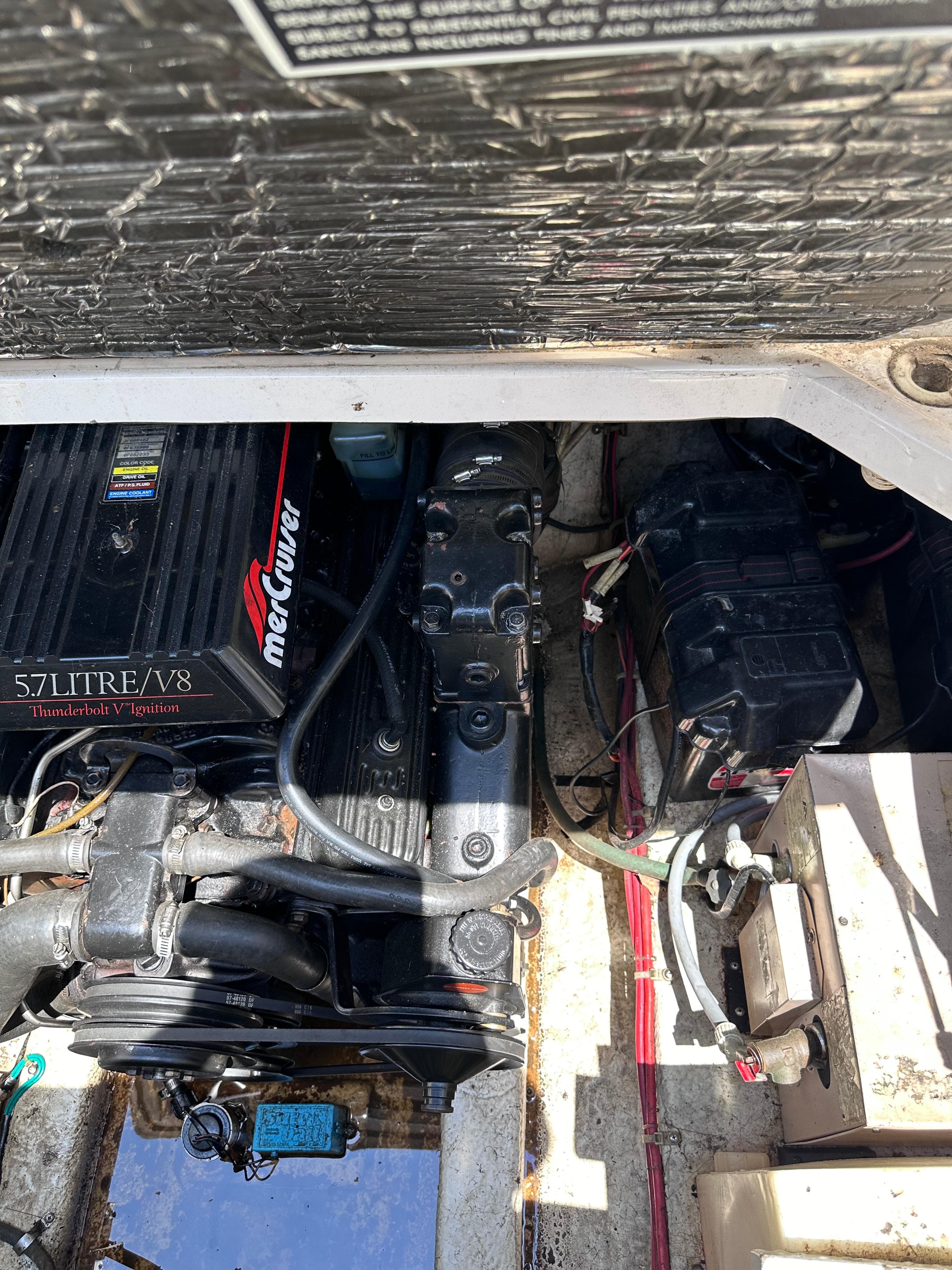 Engine compartment of a 1996 Maxum 2400 SCR boat with a 5.7L V8 MerCruiser engine.
