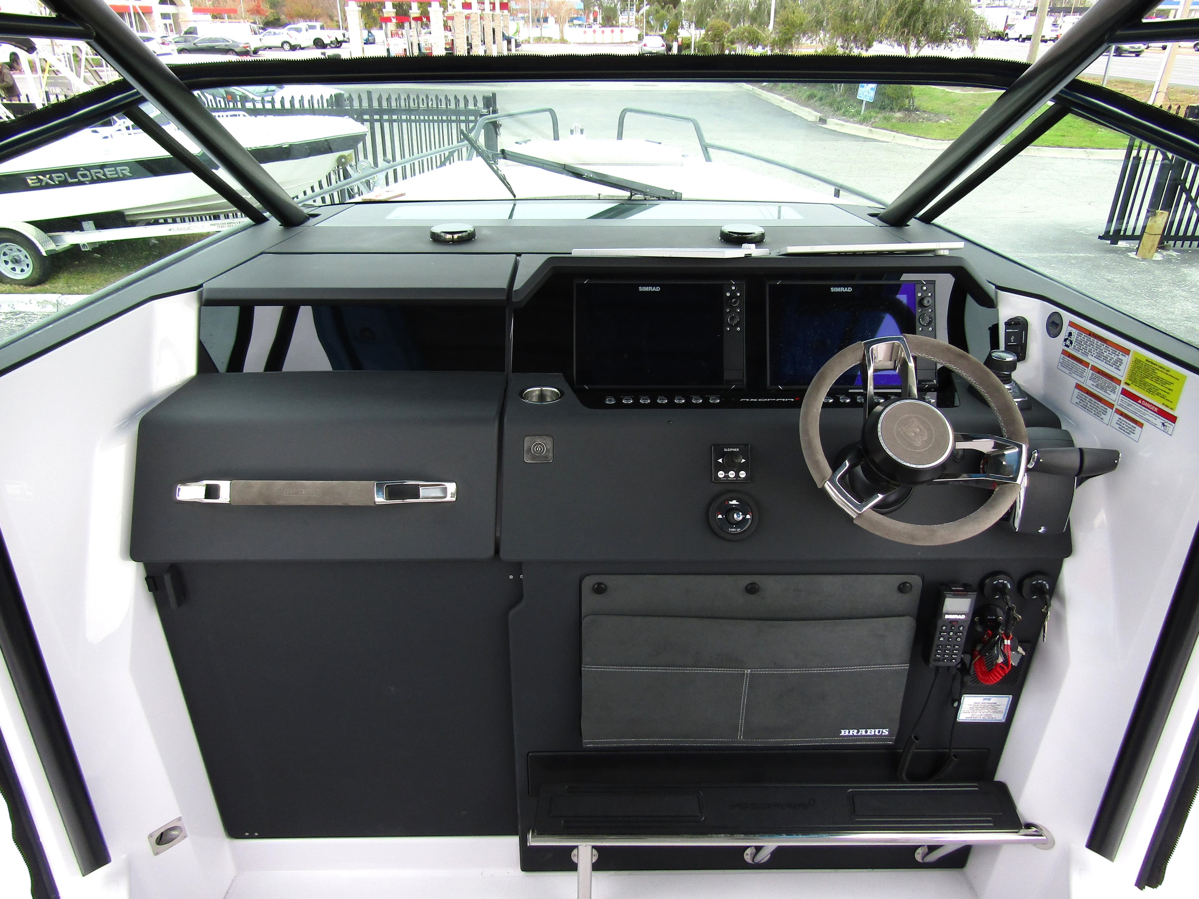 2024 Axopar 37 Sun Top helm with modern navigation controls and steering wheel.
