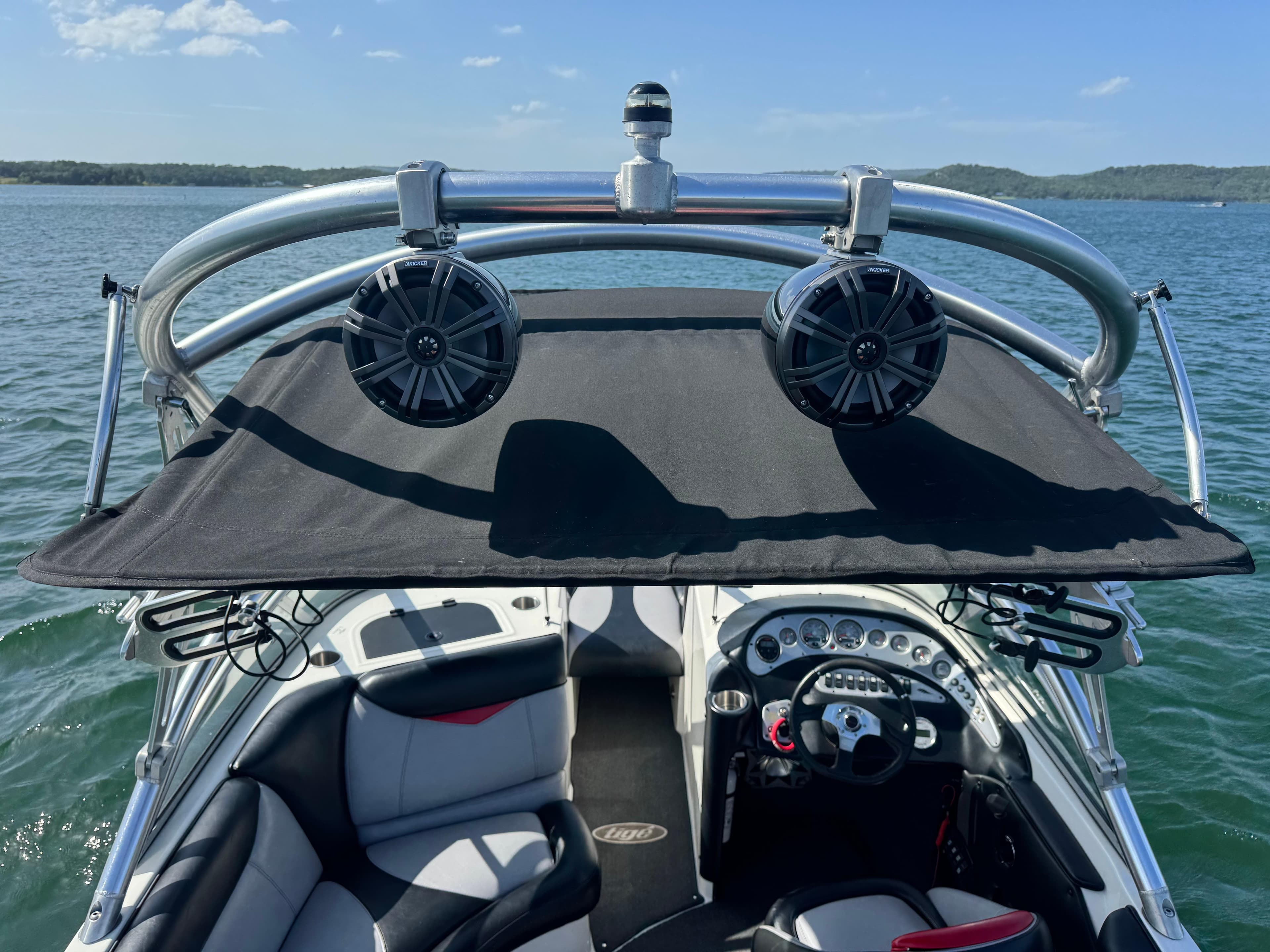 2006 Tigé 22V boat interior with speakers and canopy on a sunny lake.