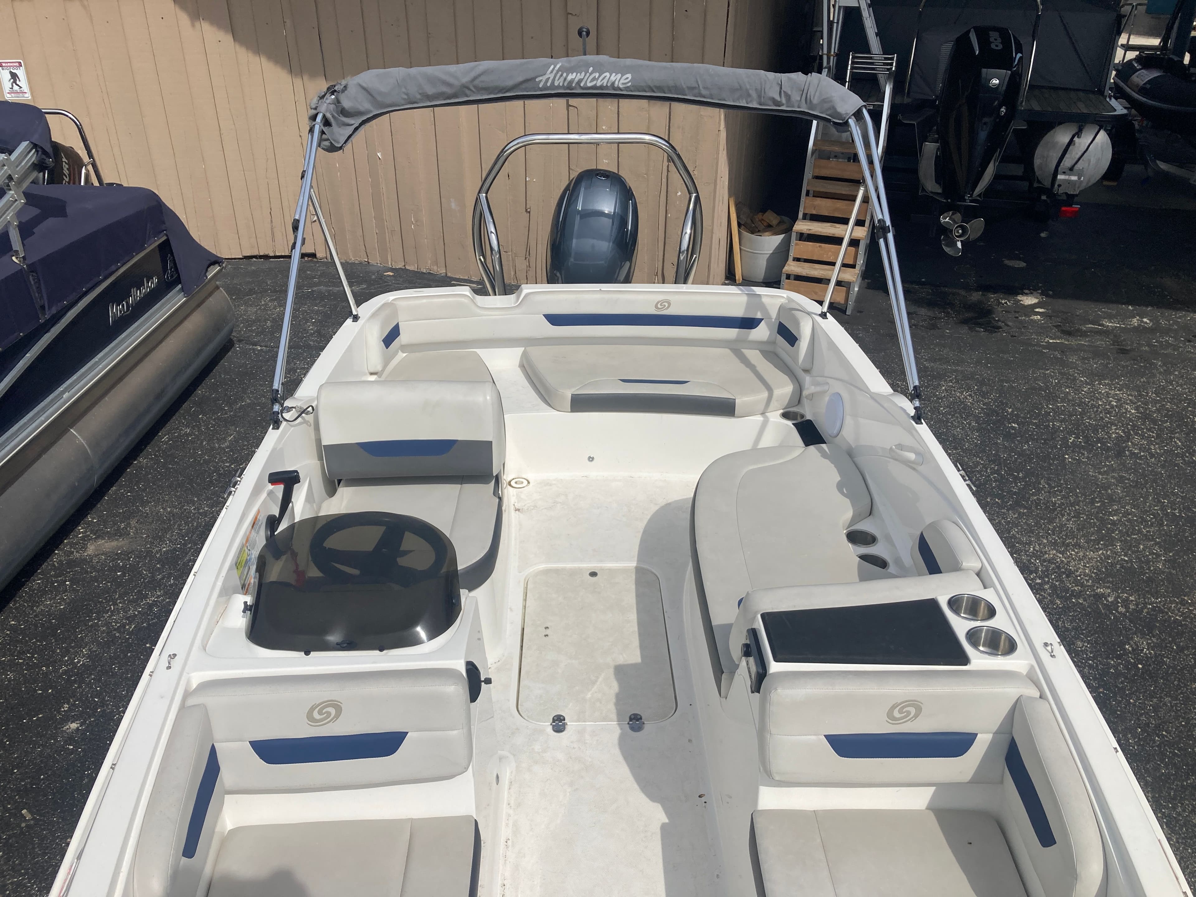 2020 Hurricane SunDeck Sport 185 OB boat with gray canopy.