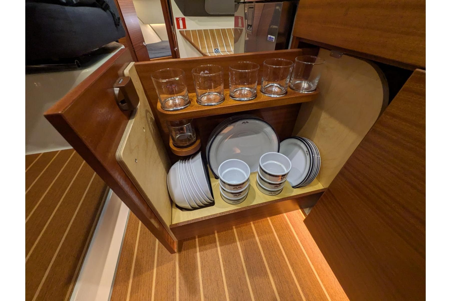 Cabinet with glassware and dishes inside 2016 Nimbus Boats 305 Coupé kitchen.