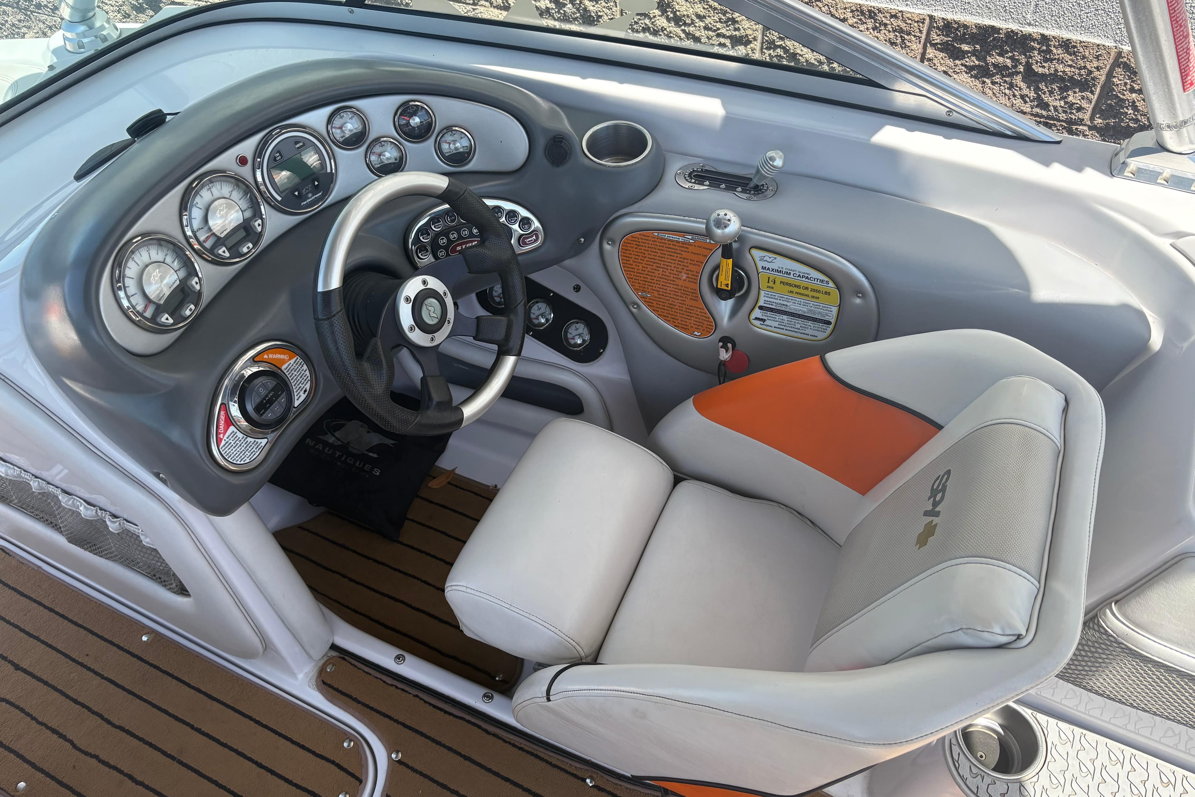 2007 Nautique Super Air Nautique 220 dashboard with steering wheel and gauges.