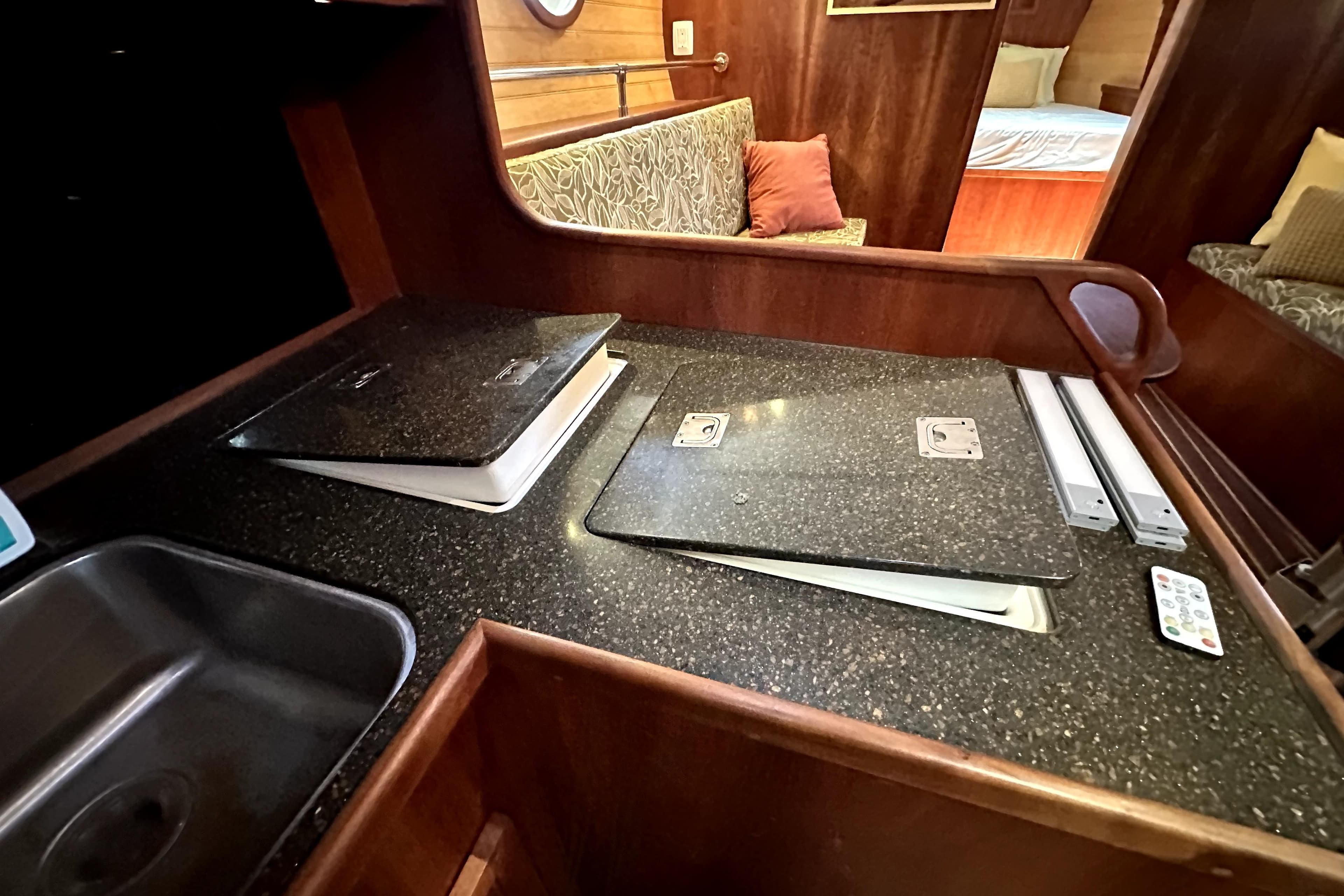 Luxurious interior of 2012 Custom Pacific Northwest 43 yacht with modern kitchen and cozy seating.