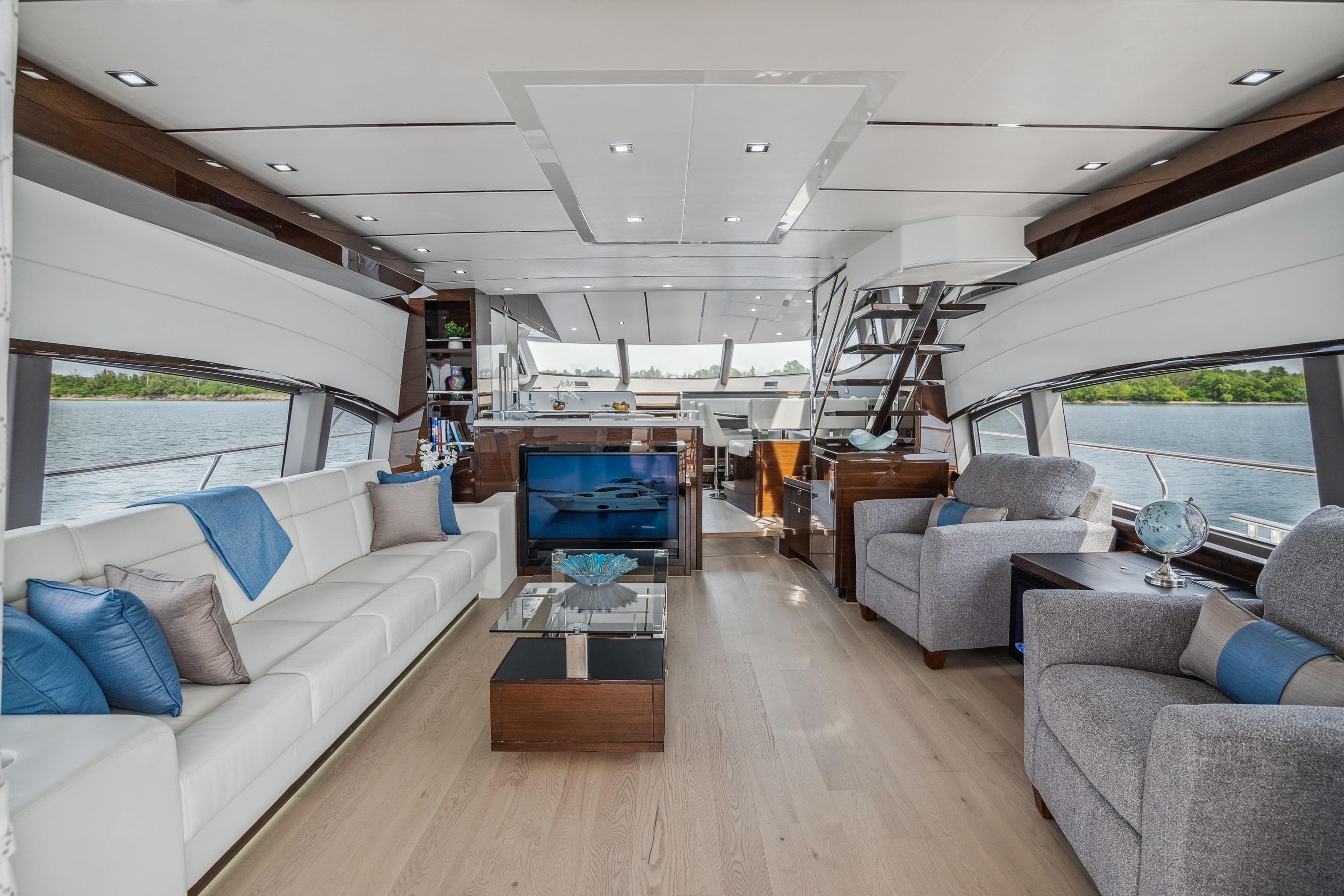 Luxurious interior of 2026 Neptunus 750SL yacht with modern furnishings and panoramic windows.