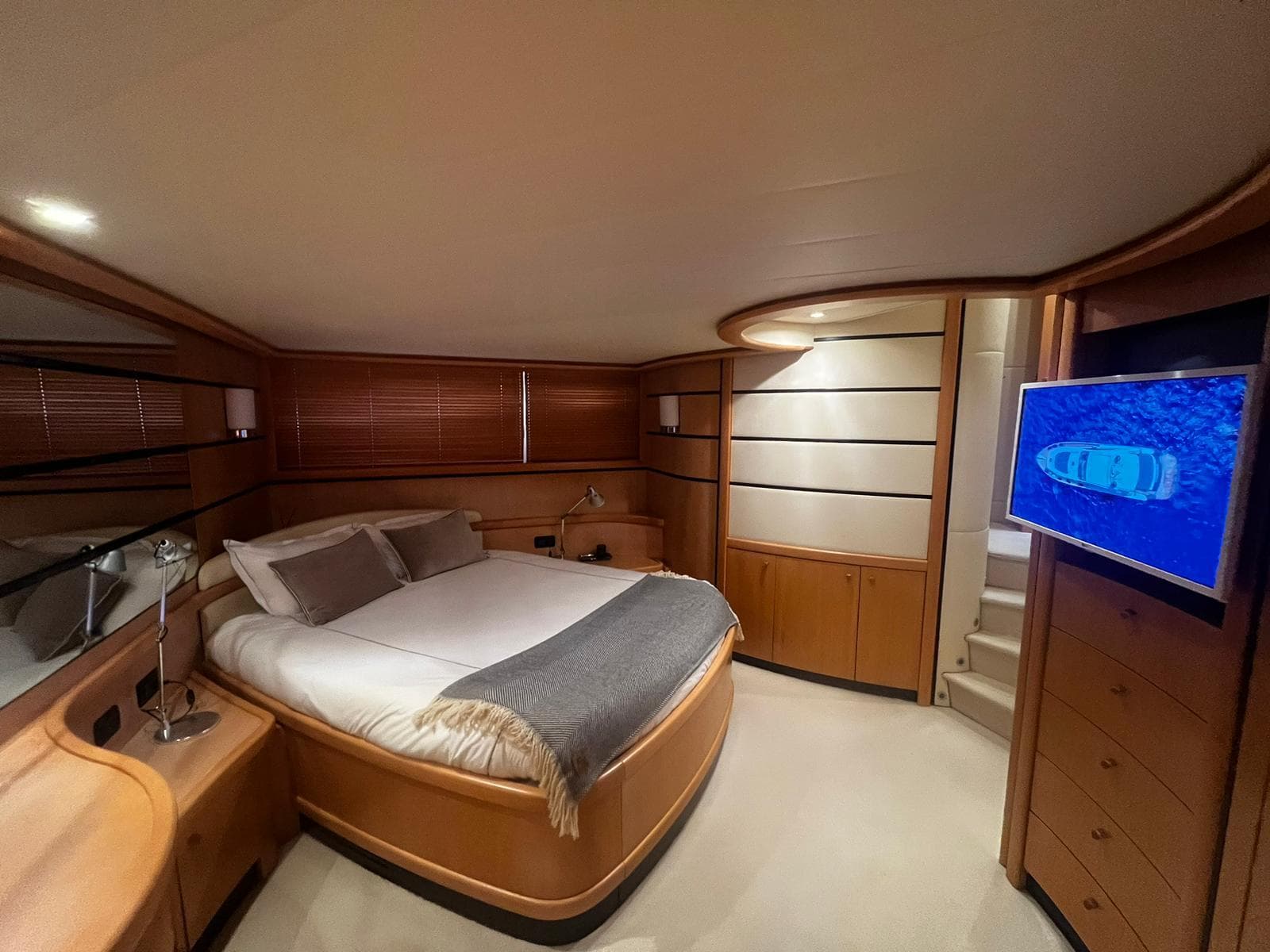 Luxurious bedroom interior of a 2004 Pershing 76 yacht with modern furnishings.