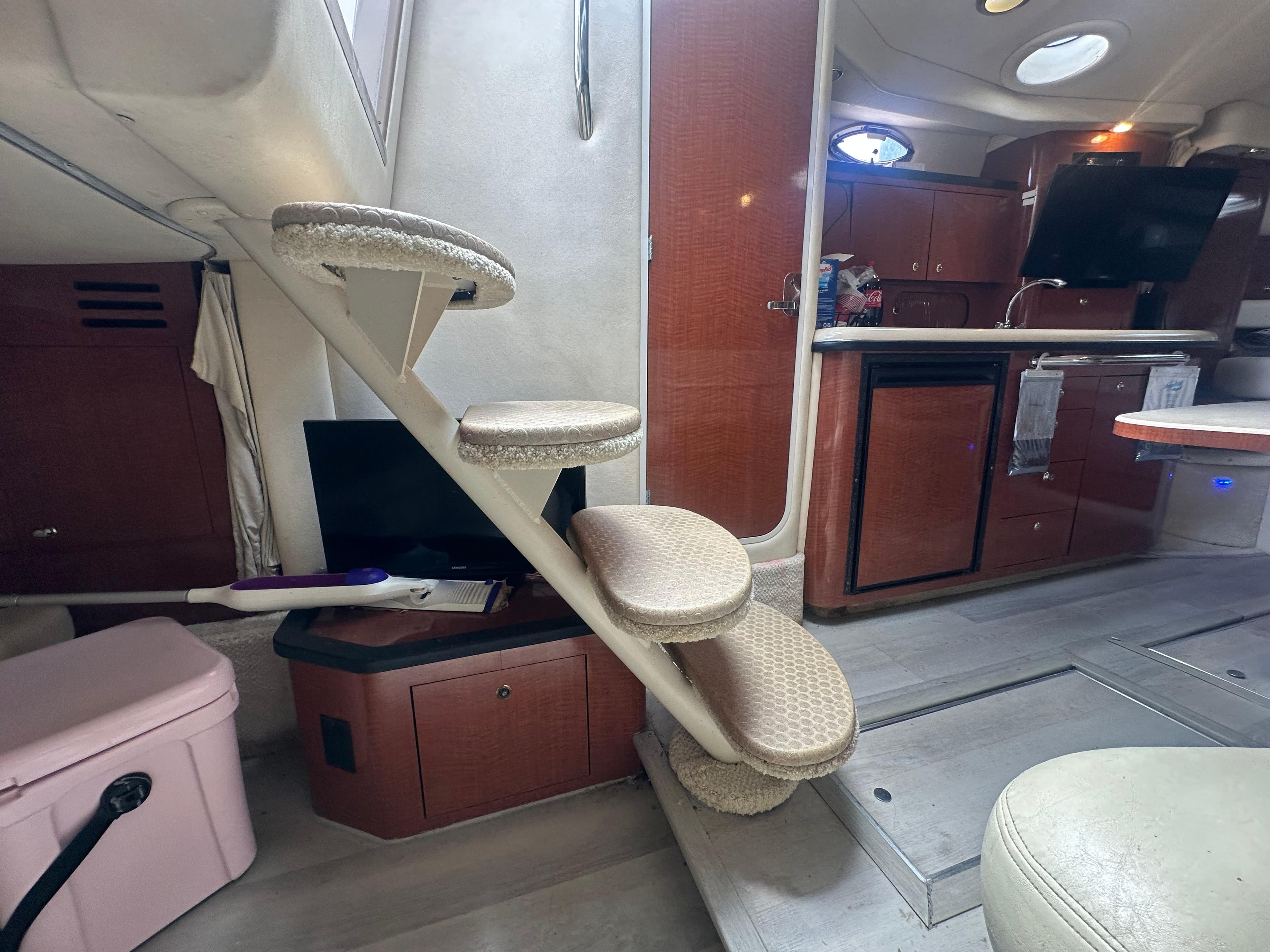 Interior of 2004 Sea Ray 340 Sundancer with stairs, kitchenette, and seating area.