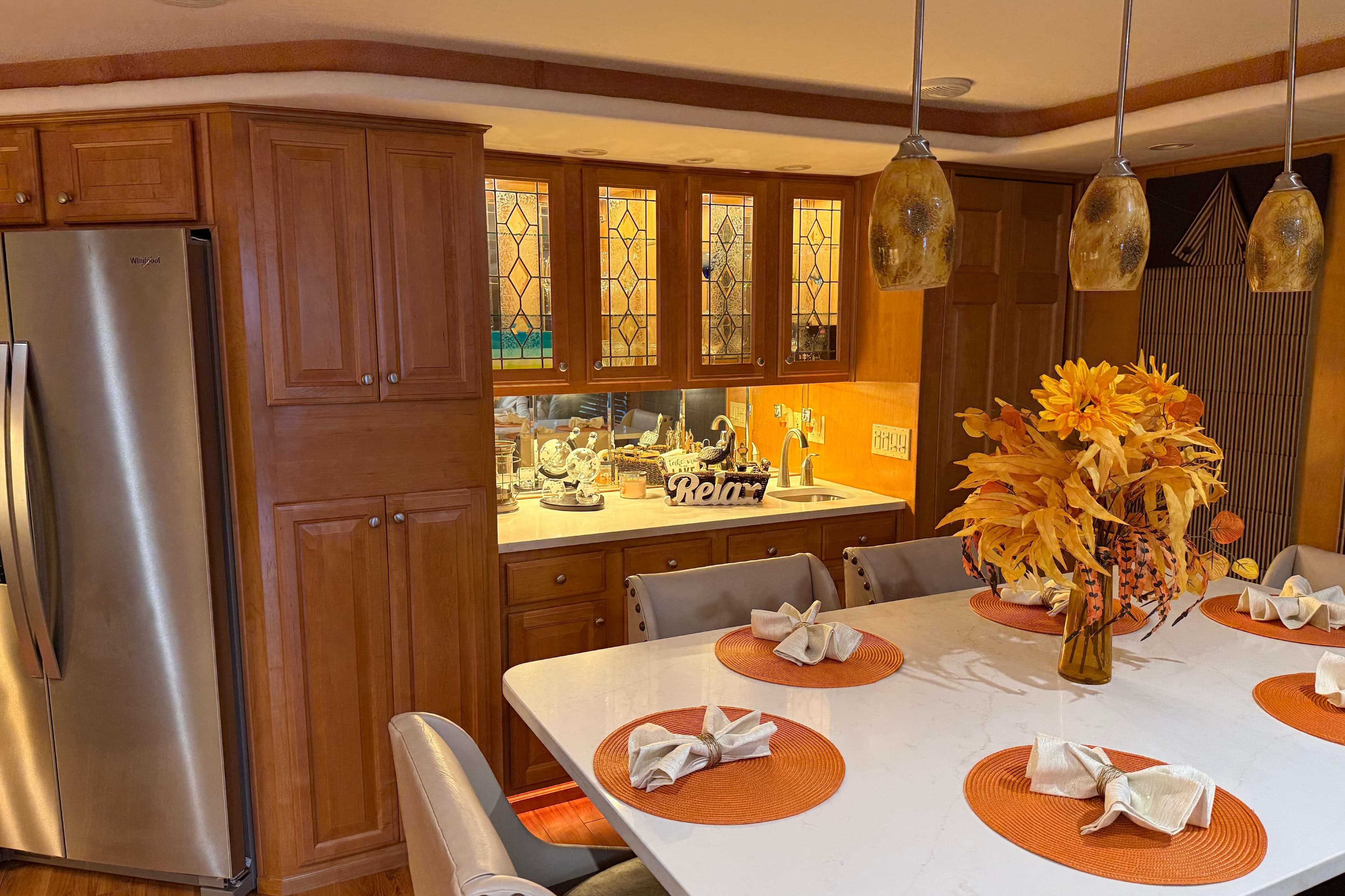 Luxurious kitchen interior with autumn decor, featuring wooden cabinets and modern lighting in a 2001 Sharpe model.