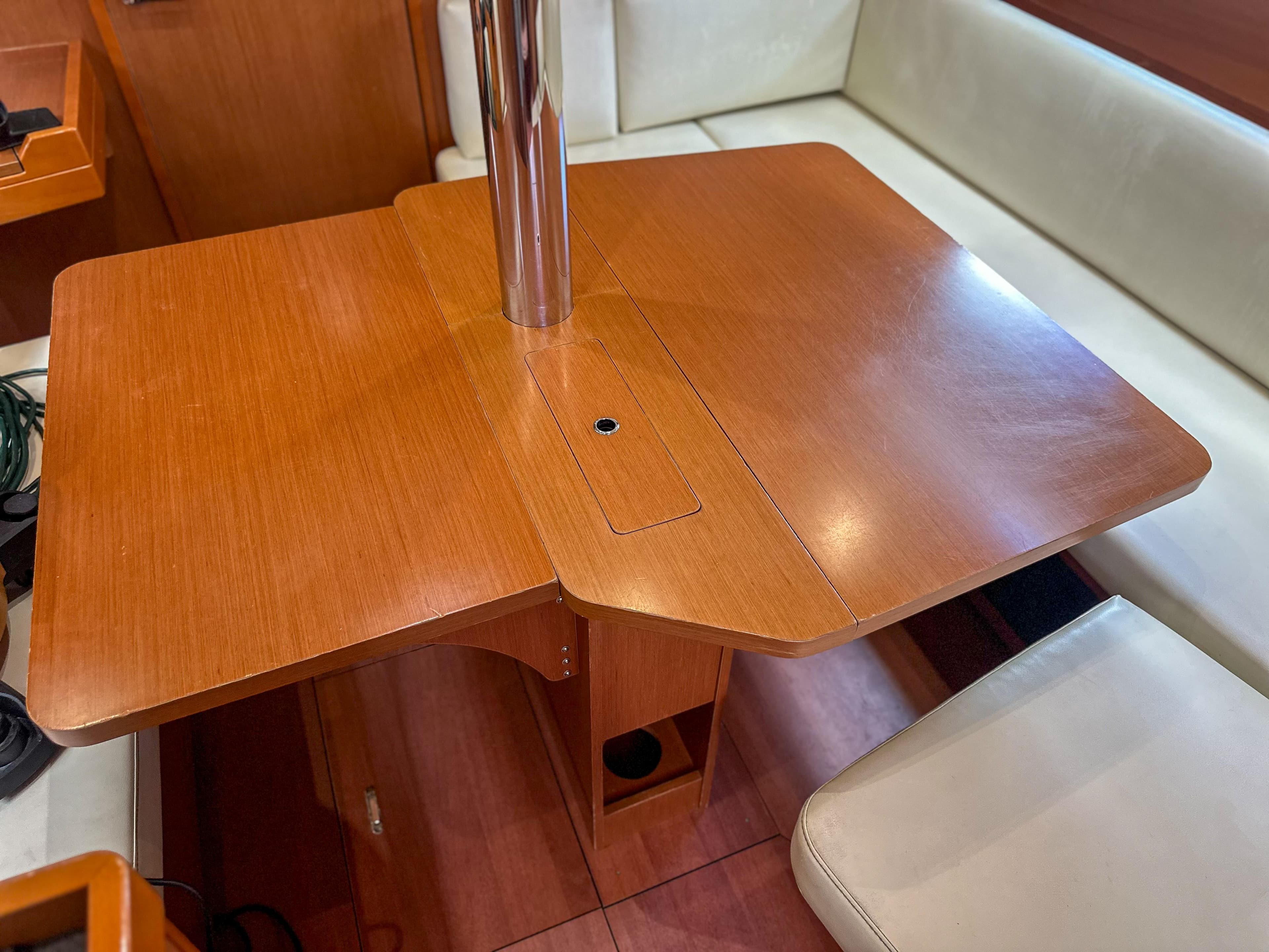 Interior of 2018 Beneteau Oceanis 41.1 yacht with wooden dining table and seating.