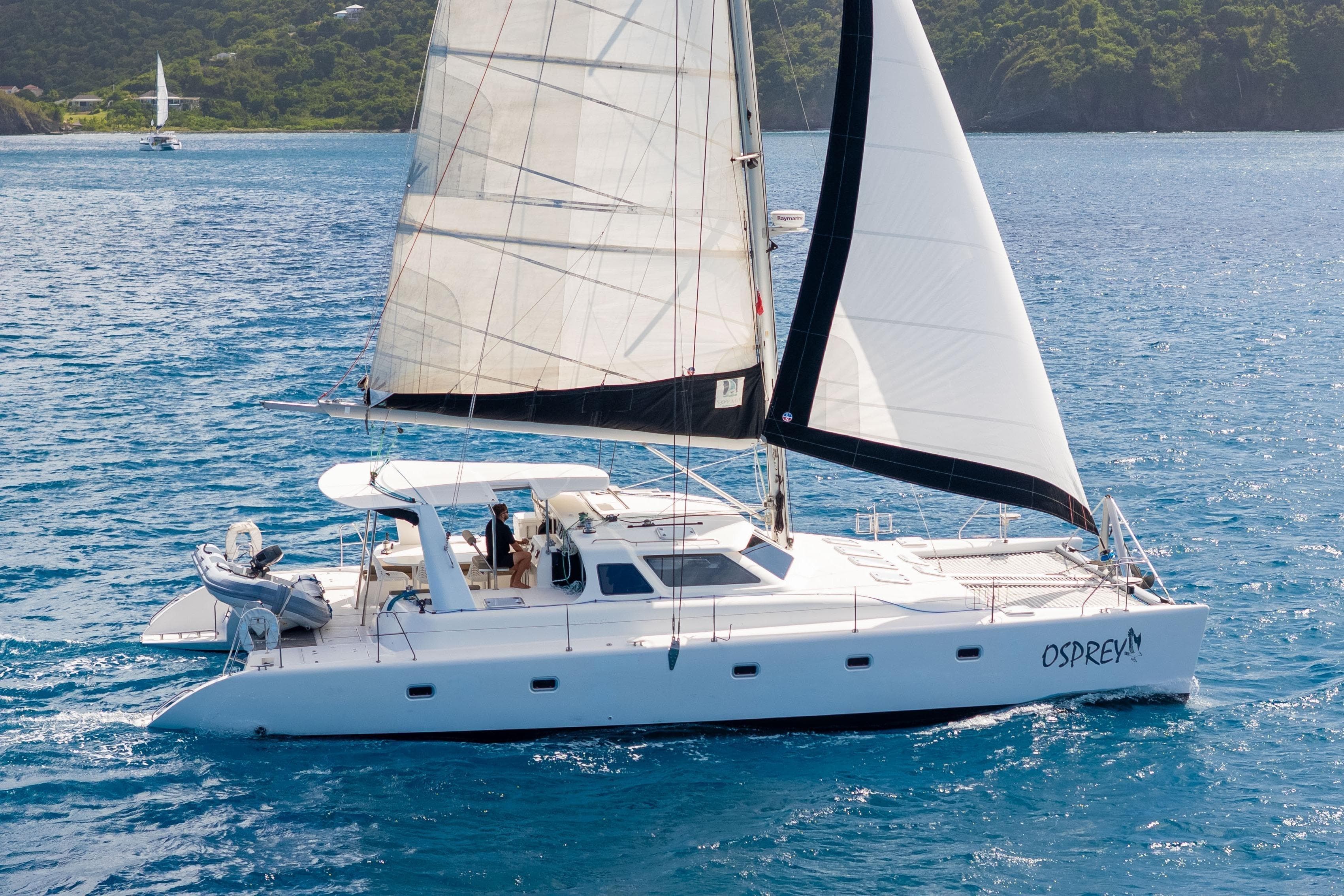 Sailing catamaran Voyage Yachts 520, 2011 model, cruising on clear blue waters.